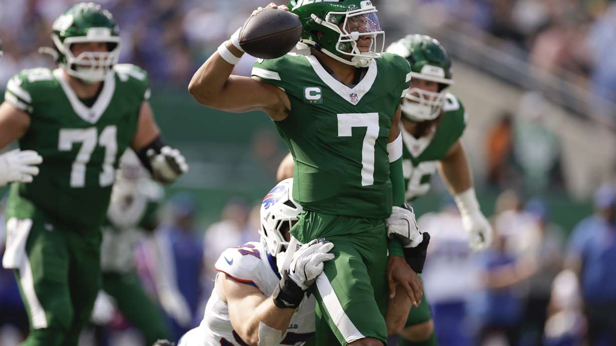 New York Jets quarterback Justin Fields (7) is sacked by Buffalo Bills defensive end Joey Bosa (97) during the fourth quarter of an NFL football game, Sunday, Sept. 14, 2025, in East Rutherford, N.J.