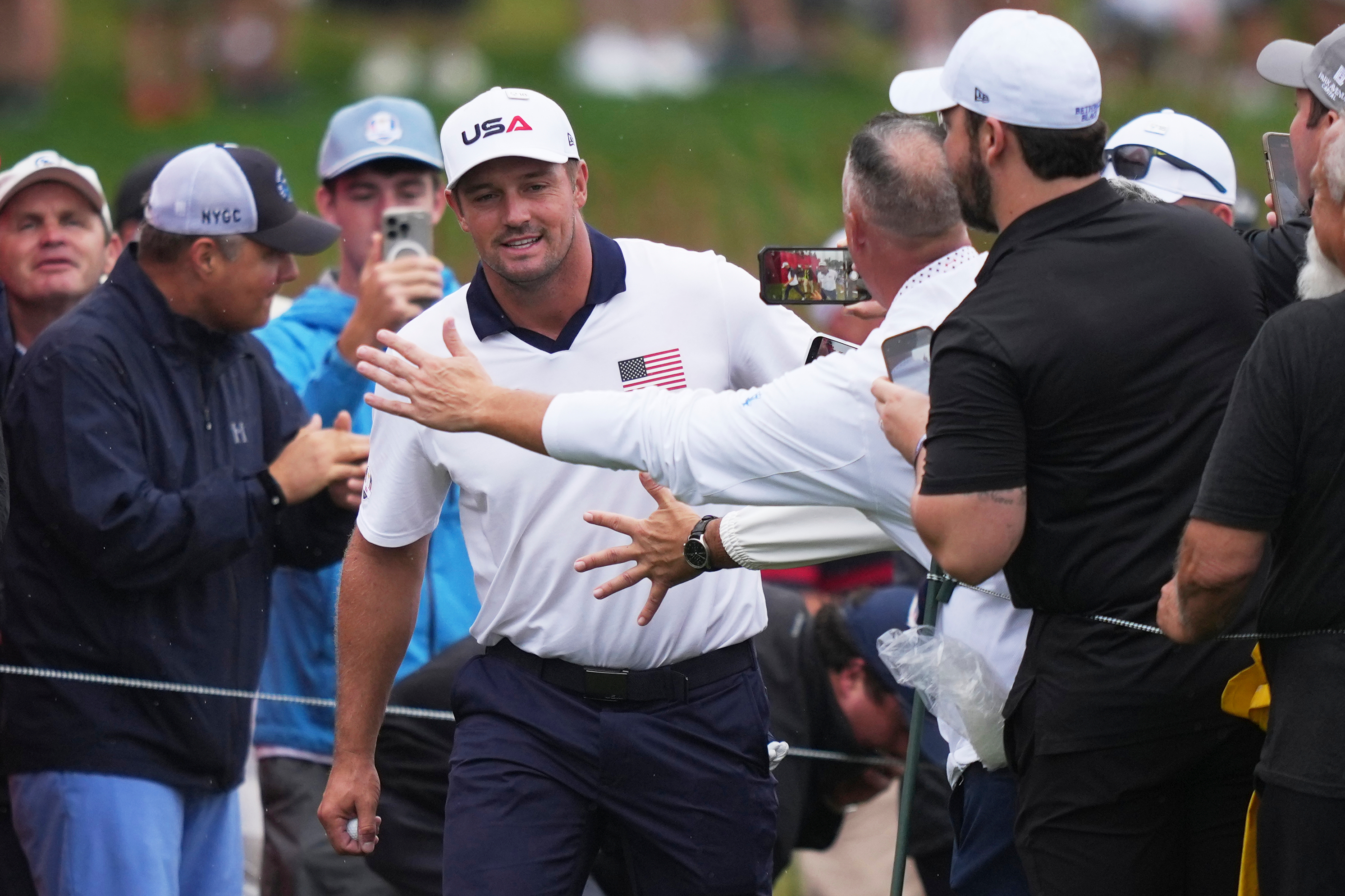Fans greets United States' Bryson DeChambeau on the 17th hole during a practice round at the Ryder Cup golf tournament, Thursday, Sept. 25, 2025, on the Bethpage Black golf course, in Farmingdale, N.Y.