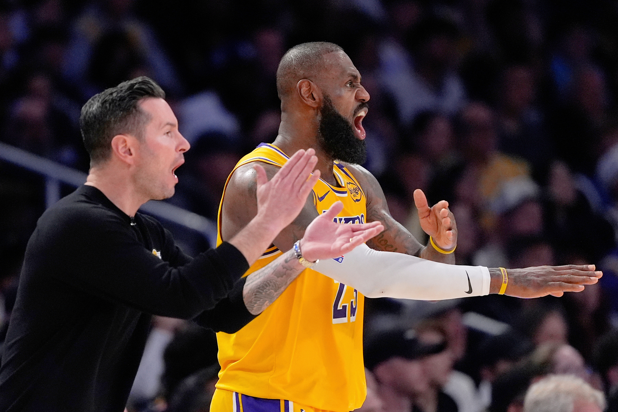 FILE - Los Angeles Lakers head coach JJ Redick, left, and forward LeBron James yell to the referees during the second half of an NBA basketball game against the Golden State Warriors Thursday, April 3, 2025, in Los Angeles.