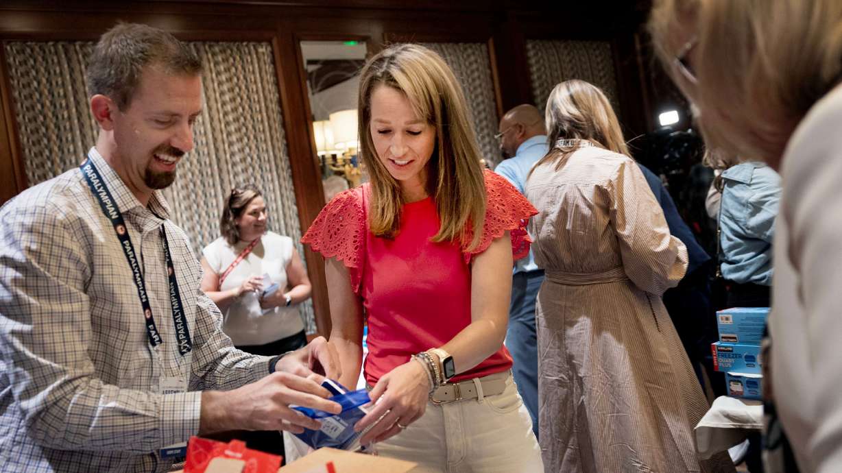 Brice Boarman and Utah first lady Abby Cox assemble snack kits at Little America in Salt Lake City on Thursday. Cox called Thursday's project a chance for Olympic officials to see "what Utah does best."