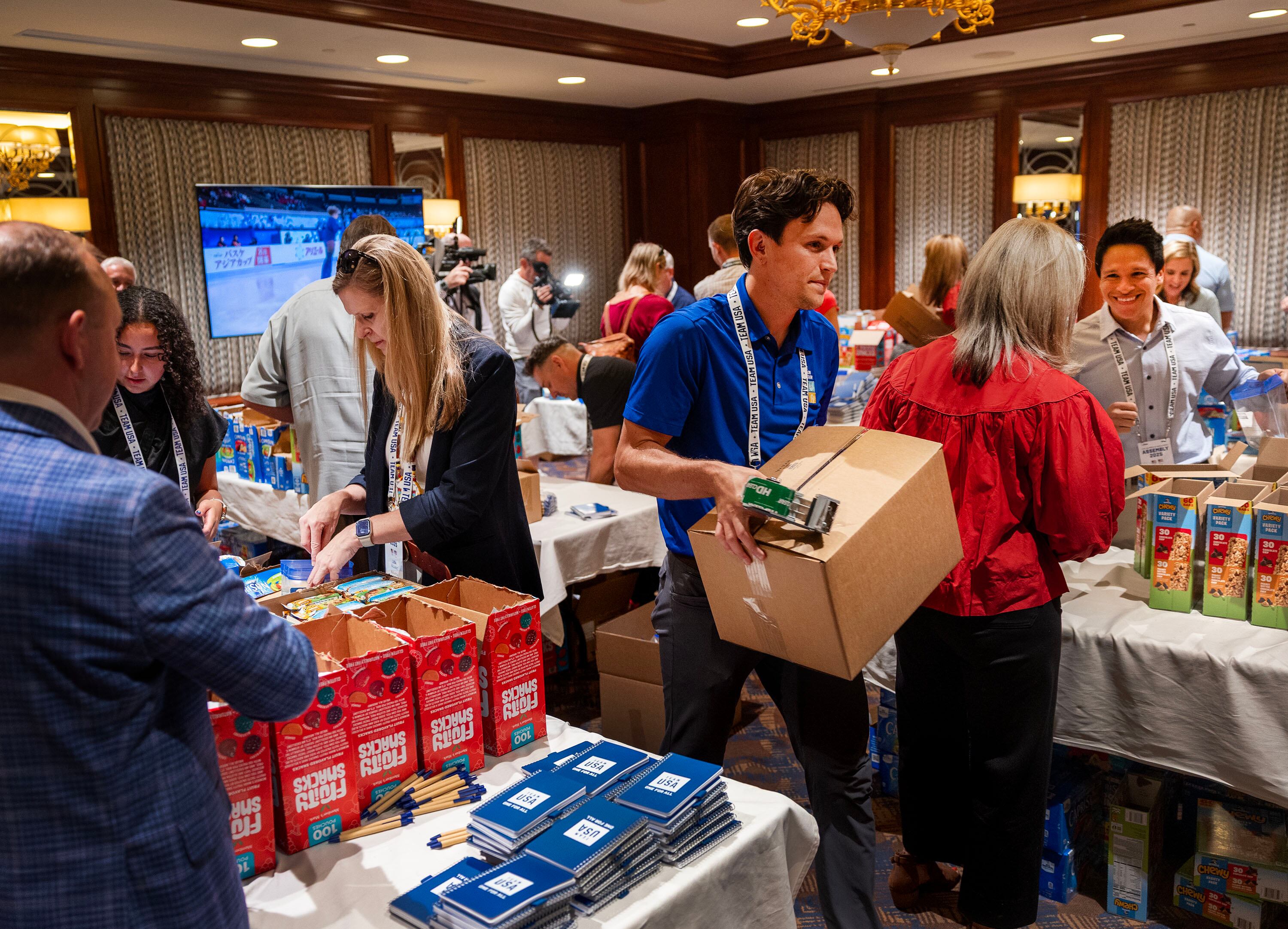 Snack kits are assembled during Utah first lady Abby Cox’s Show Up initiative at Little America in Salt Lake City on Thursday. Cox called it a chance for officials to see "what Utah does best."