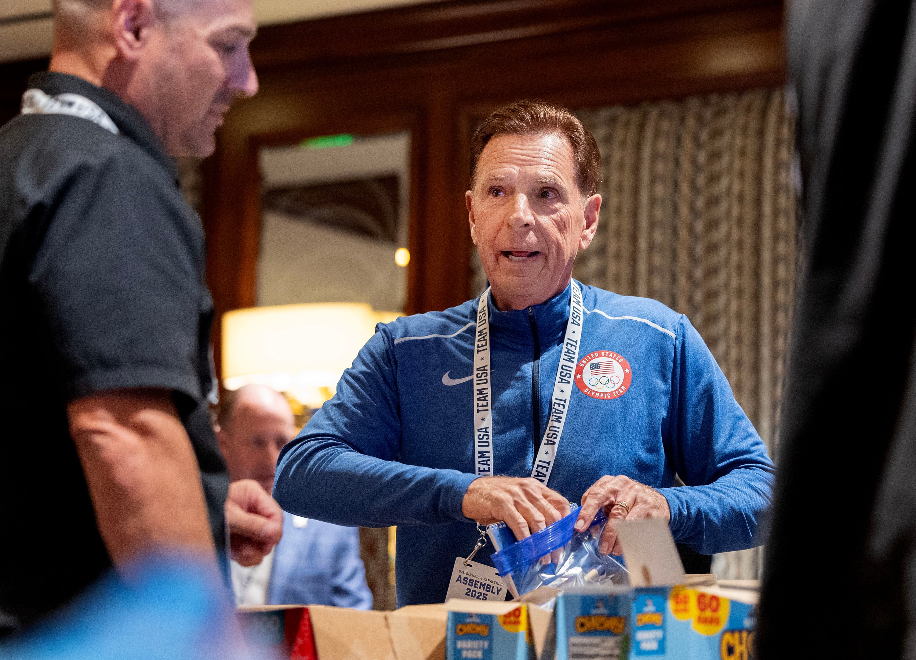 Fraser Bullock, president and CEO of the Salt Lake City-Utah Committee for the Games, assembles snack kits to be distributed by the Granite Education Foundation at Little America in Salt Lake City on Thursday. Bullock was one of several Olympic and Paralympic officials who took part in the project.
