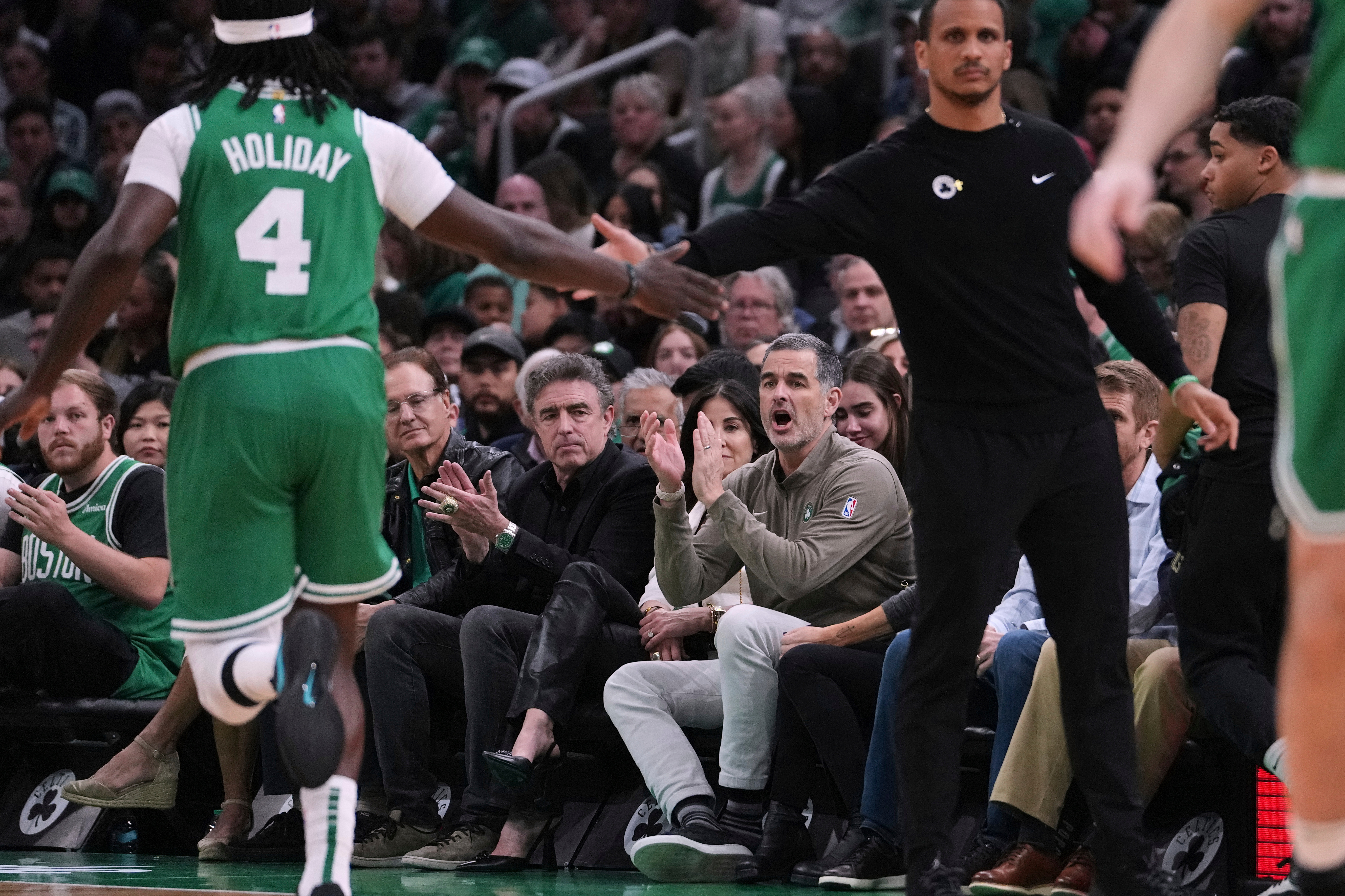 FILE - Boston Celtics owner Bill Chisholm, seated right, applauds during the first half in game 2 of a first-round NBA playoff basketball series against the Orlando Magic, April 23, 2025, in Boston. 