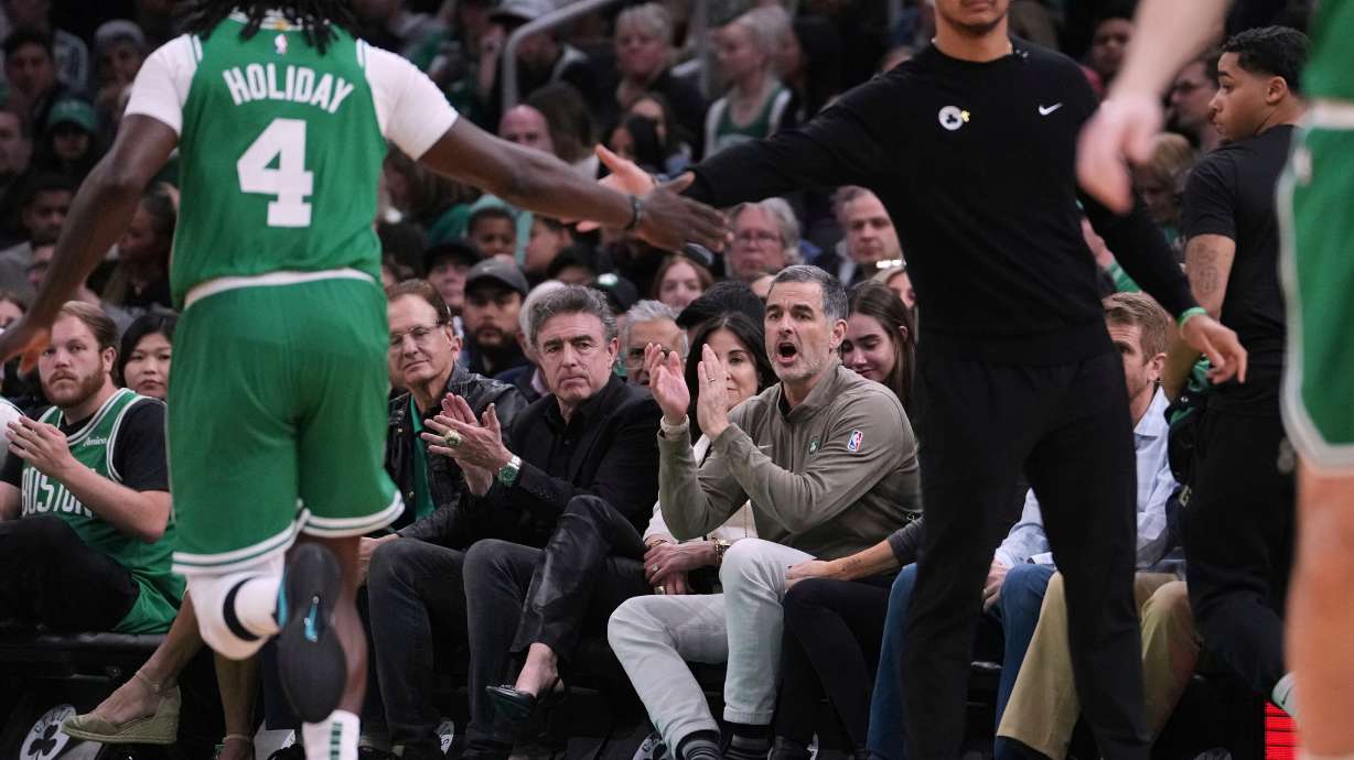 FILE - Boston Celtics owner Bill Chisholm, seated right, applauds during the first half in game 2 of a first-round NBA playoff basketball series against the Orlando Magic, April 23, 2025, in Boston.