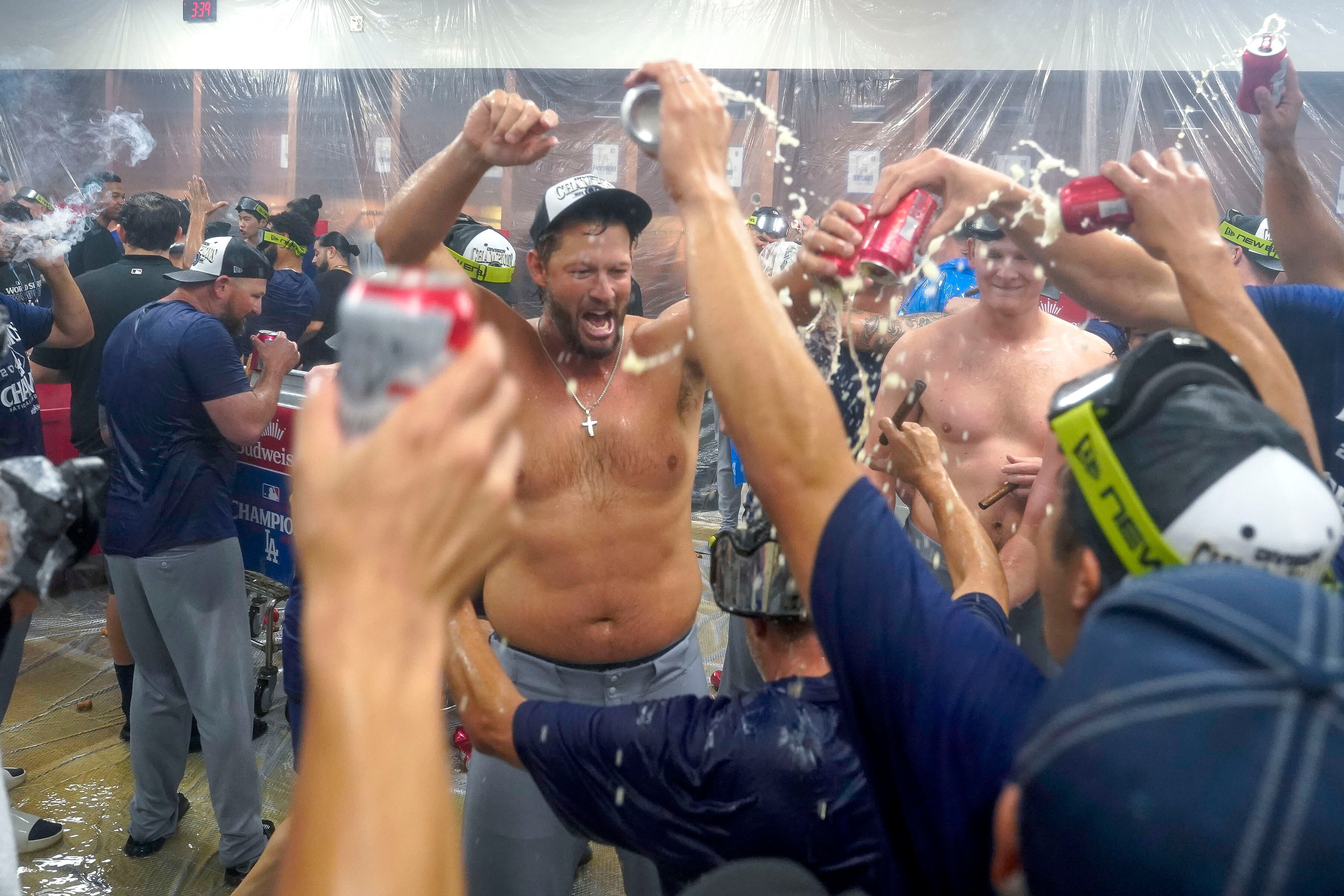Los Angeles Dodgers pitcher Clayton Kershaw, center, celebrates with his teammates after the Dodgers clinched the National League West title against the Arizona Diamondbacks during a baseball game at Chase Field Thursday, Sept. 25, 2025, in Phoenix. 
