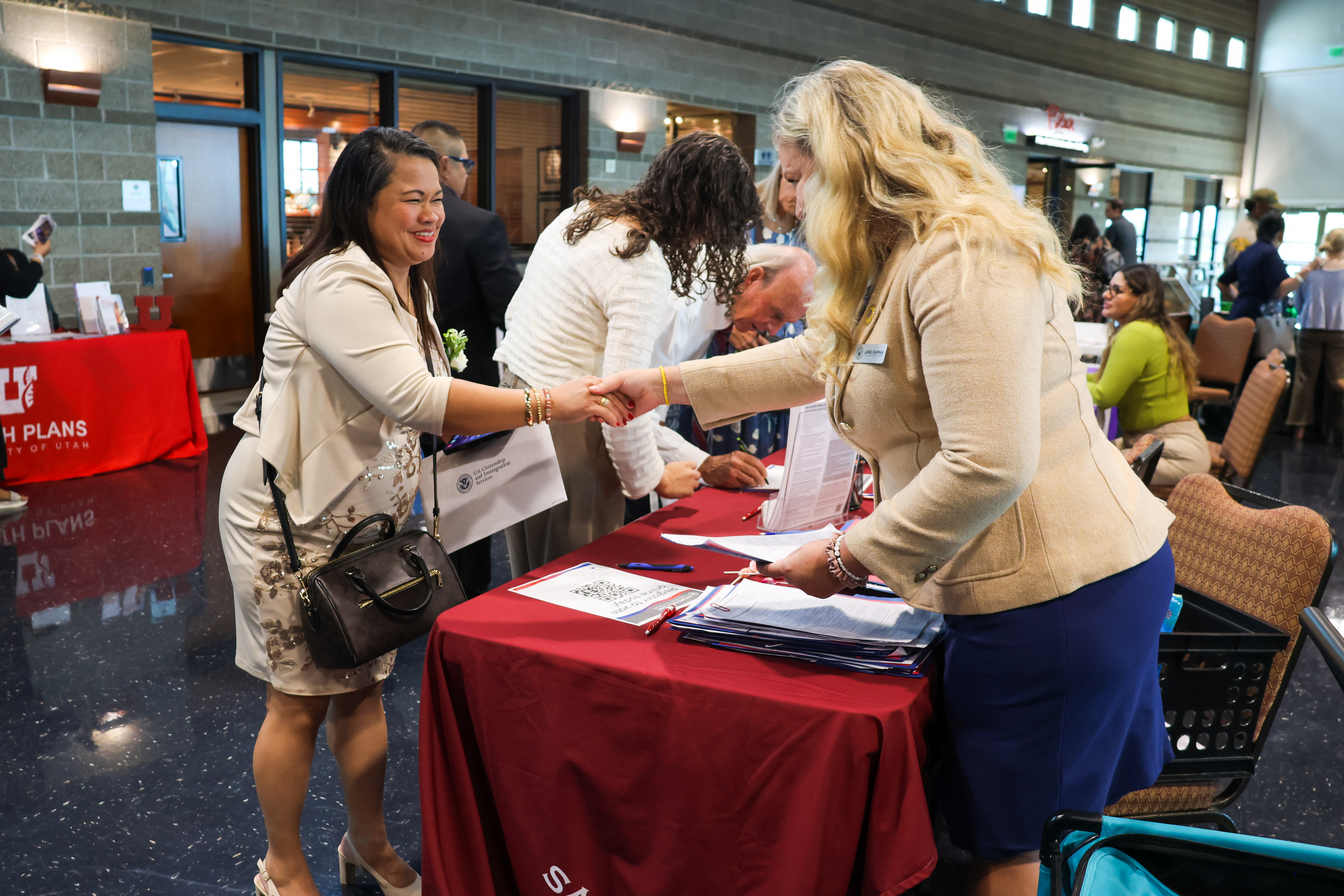 Salt Lake County Clerk Lannie Chapman, right, said her office will bolster its efforts to register new citizens to vote after a federal policy shift. She's pictured at a West Valley City naturalization ceremony on Sept. 8.