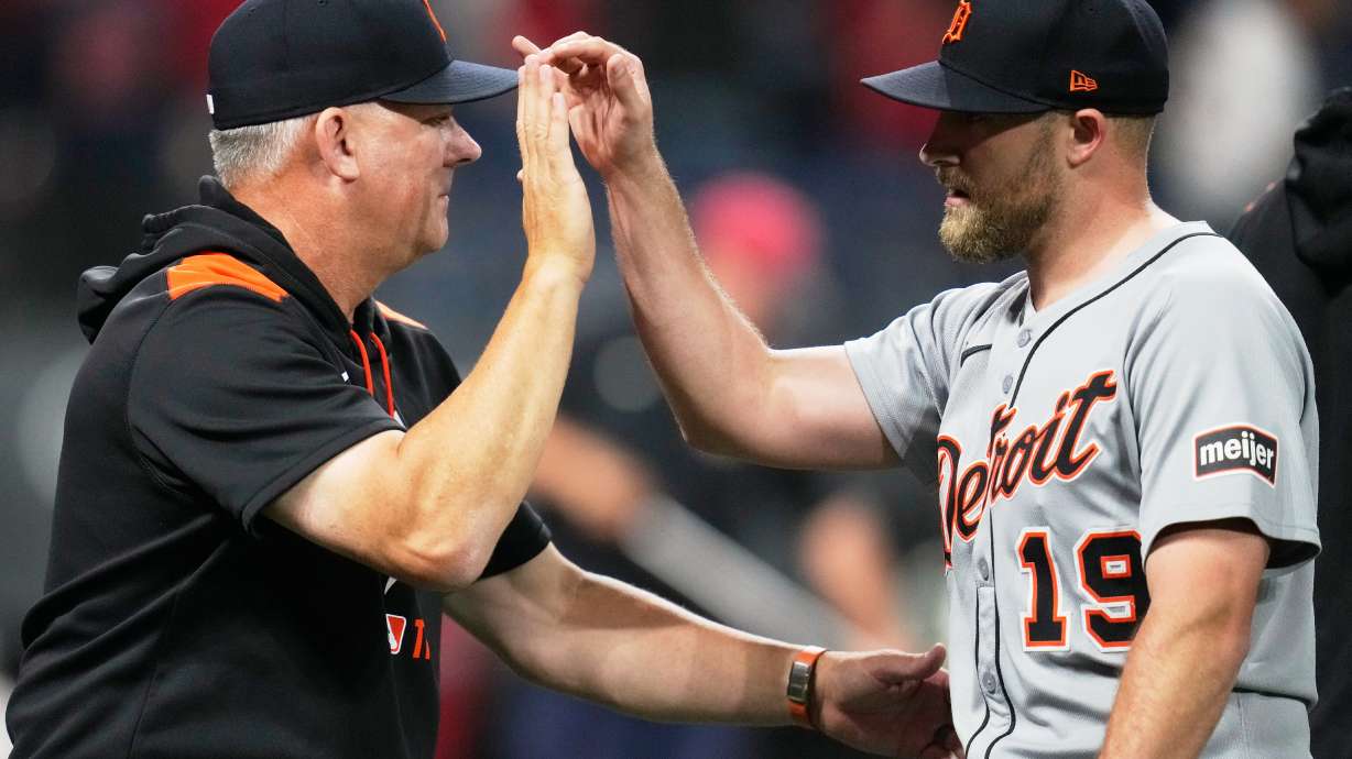 Detroit Tigers manager A.J. Hinch, left, greets relief pitcher Will Vest (19) after the Tigers defeated the Cleveland Guardians in a baseball game in Cleveland, Thursday, Sept. 25, 2025.