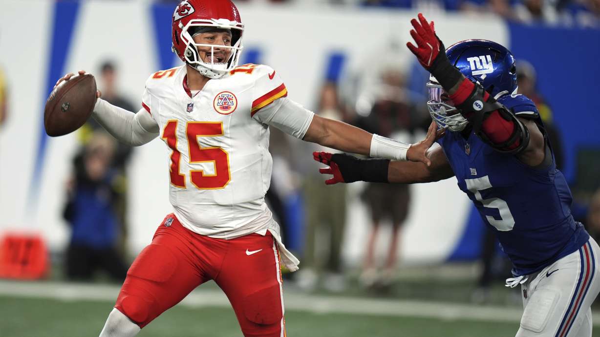 Kansas City Chiefs quarterback Patrick Mahomes throws as New York Giants outside linebacker Kayvon Thibodeaux (5) defends during the second half of an NFL football game Sunday, Sept. 21, 2025, in East Rutherford, N.J.