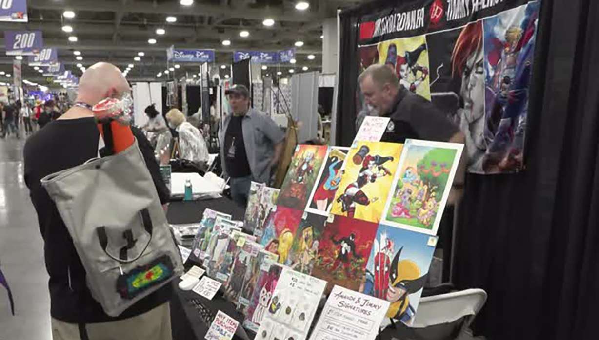 Patrons look at artwork at FanX in Salt Lake City on Thursday. Event organizers banned AI-generated art this year.