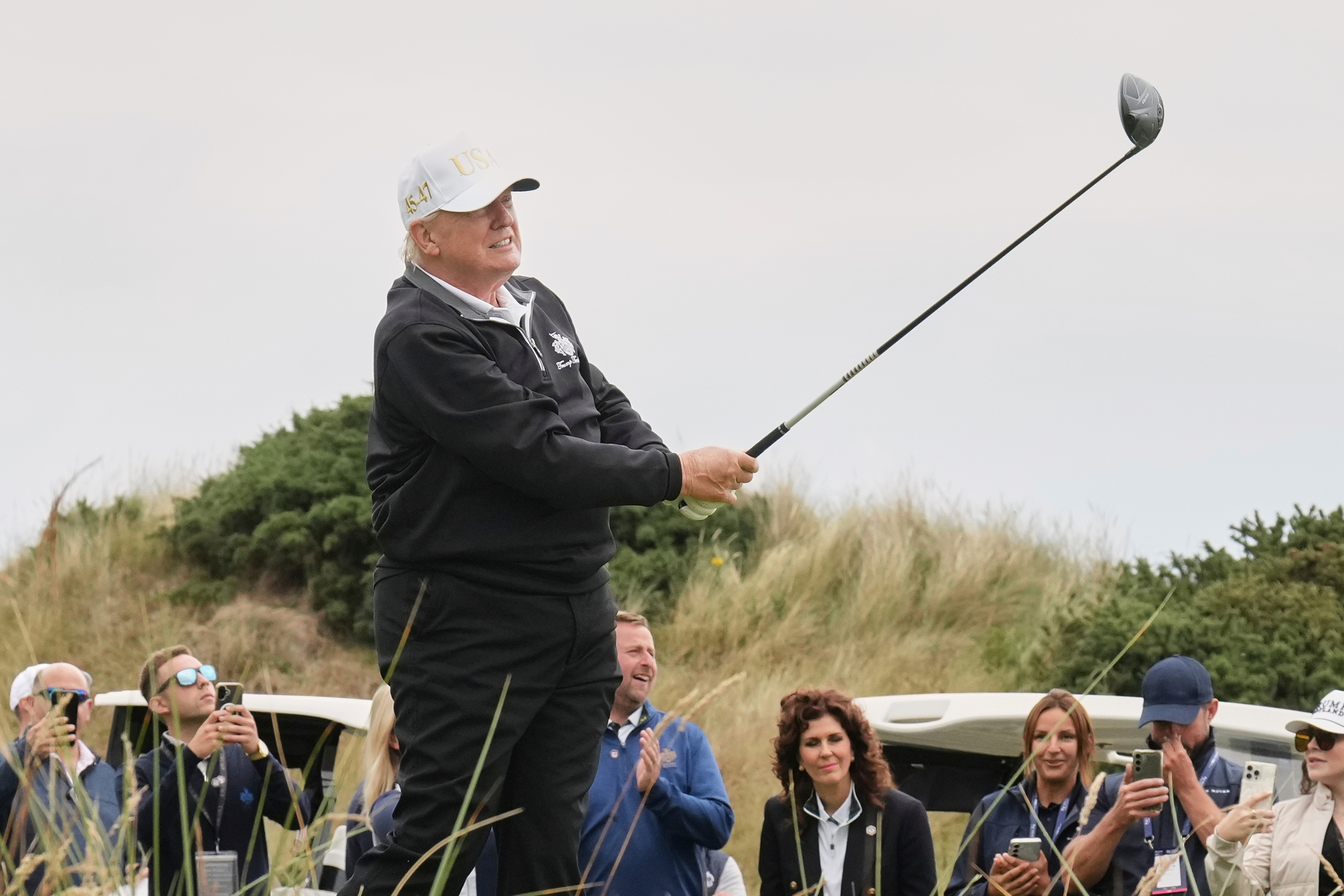 FILE - President Donald Trump tees off during the opening ceremony for the Trump International Golf Links golf course, near Aberdeen, Scotland, July 29, 2025. 