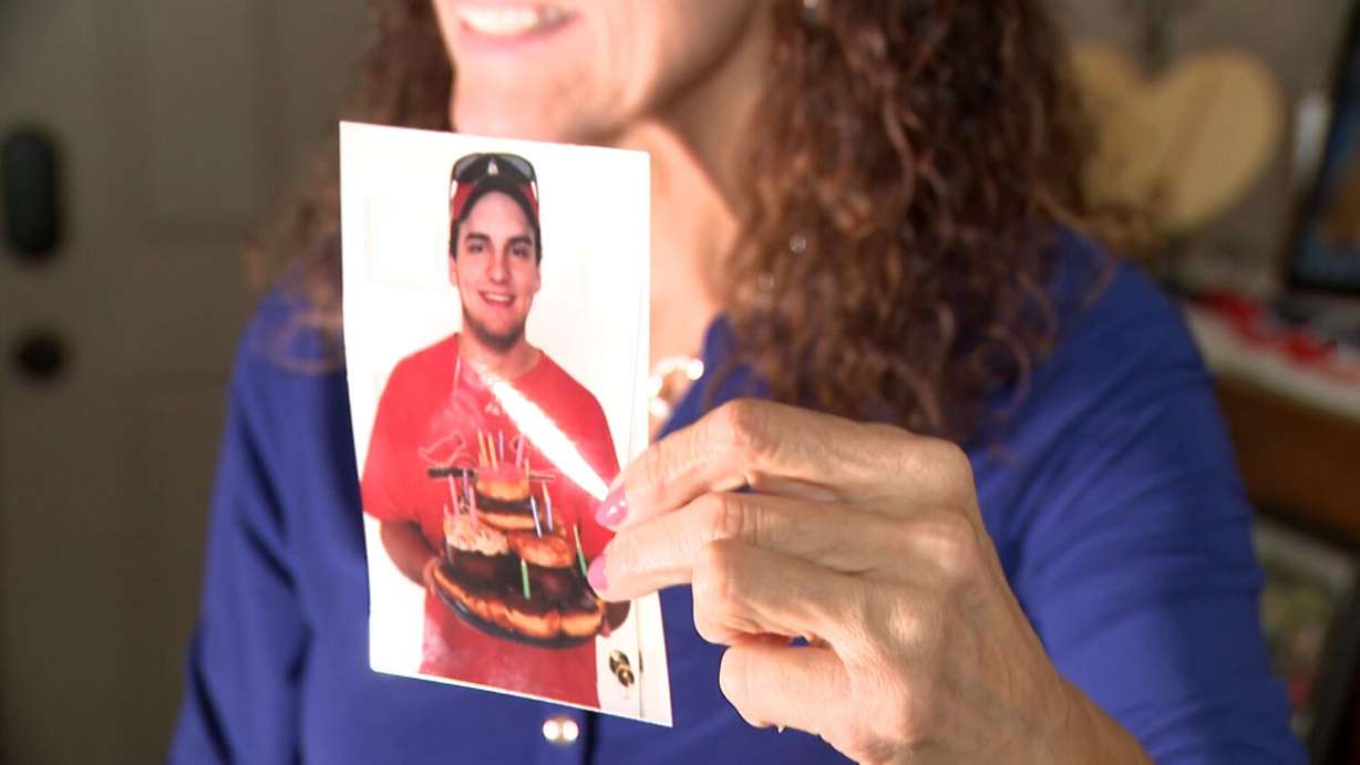 Cindy George holds up a photo of her son, Jake, on his 21st birthday.
