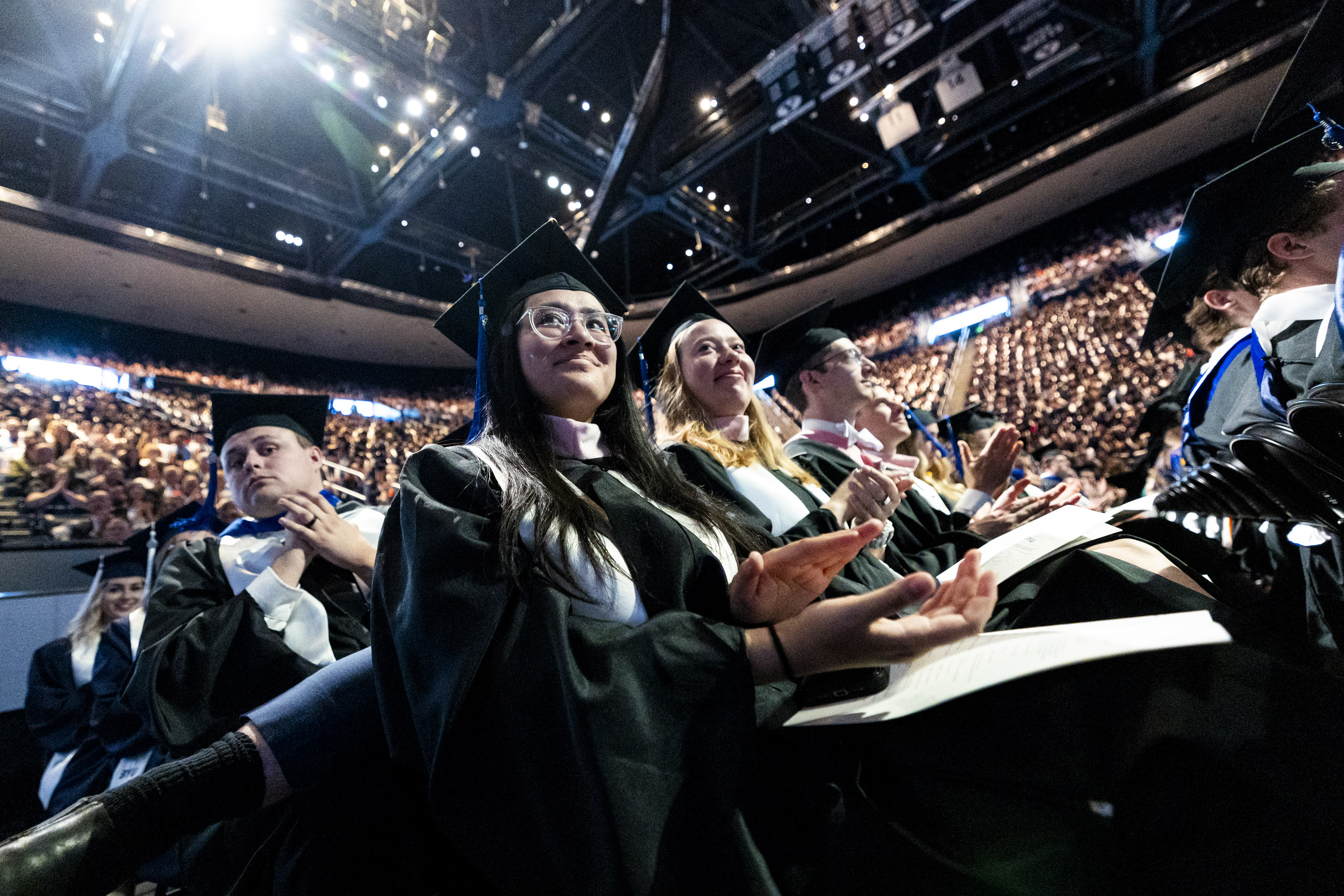 Renee Chiu Gastelum, graduating with a master’s degree in organ performance, claps during Brigham Young University’s commencement ceremony, held at the Marriott Center in Provo on April 24.