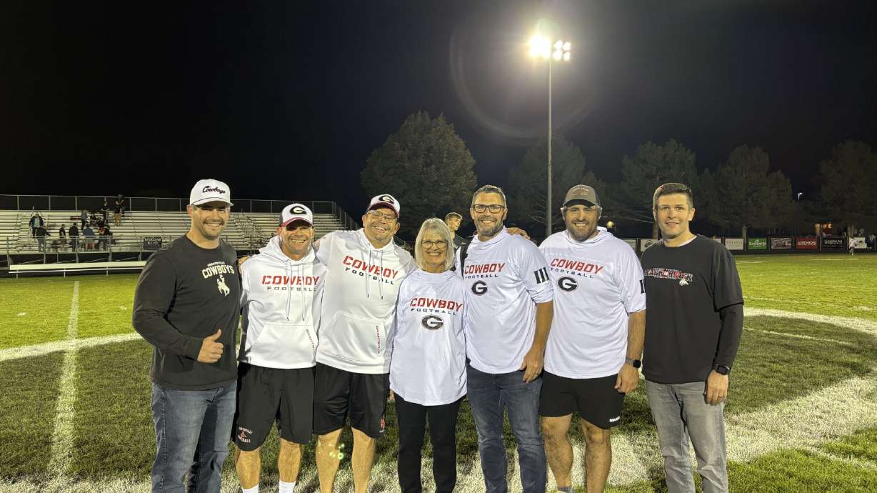 Kathy Mouritsen and her six sons gather after a Grantsville high school football game (From left to right, Brent, Scott, Alan, Kathy, Rich, Kevin, and Carl Mouritsen).