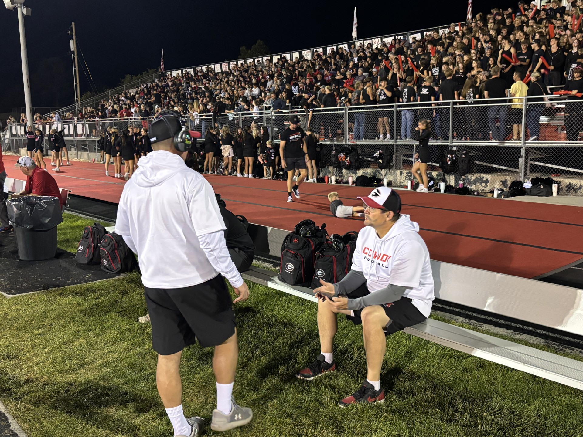 Scott and Alan Mouritsen chat on the sideline during Grantsville's homecoming game.