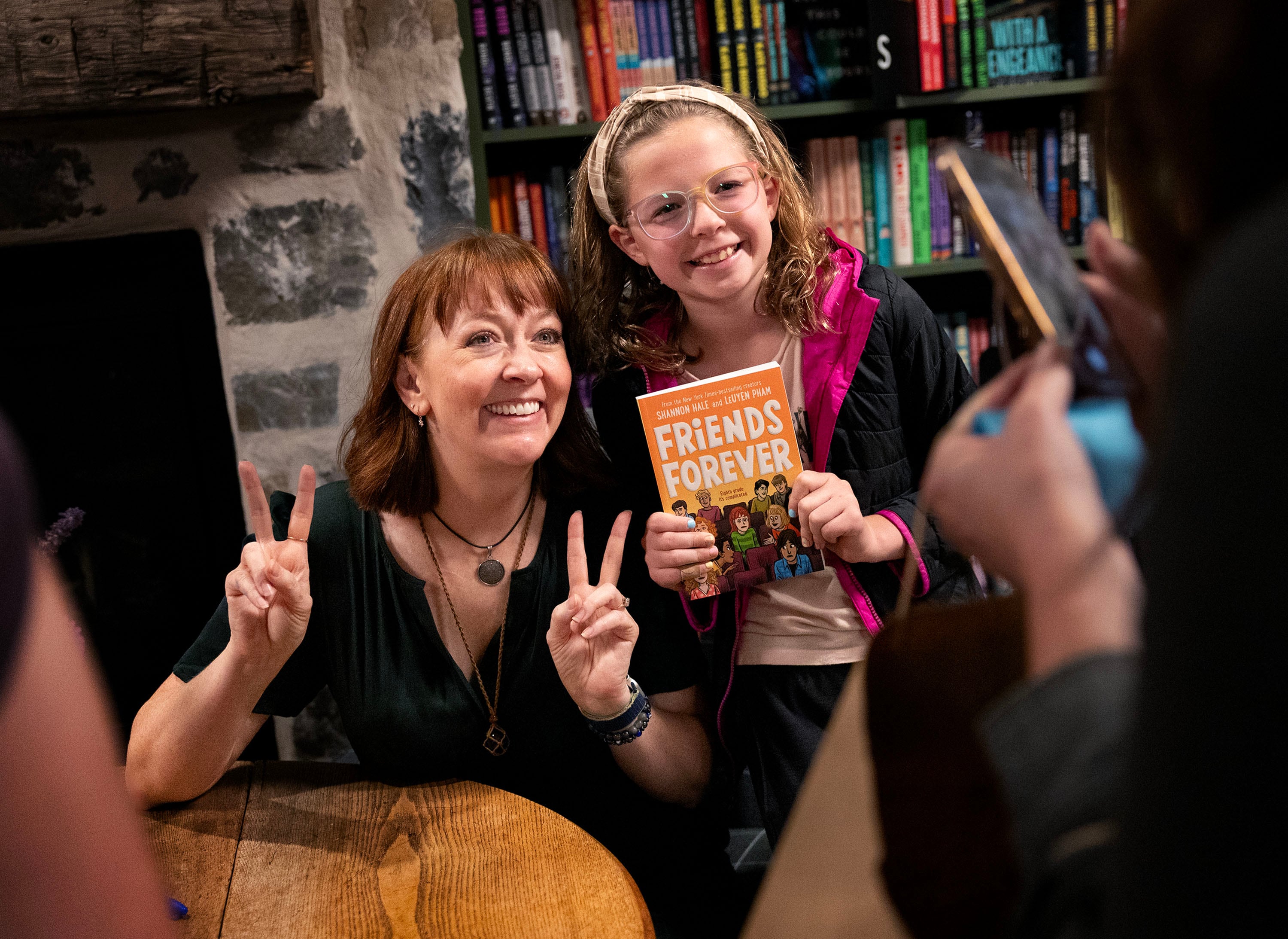 Author Shannon Hale takes a photo with Peyton Labarge at Folklore Bookshop in Midway on Sept. 17. Hale reflected on the impact of her third novel, "Princess Academy," which was first published 20 years ago.