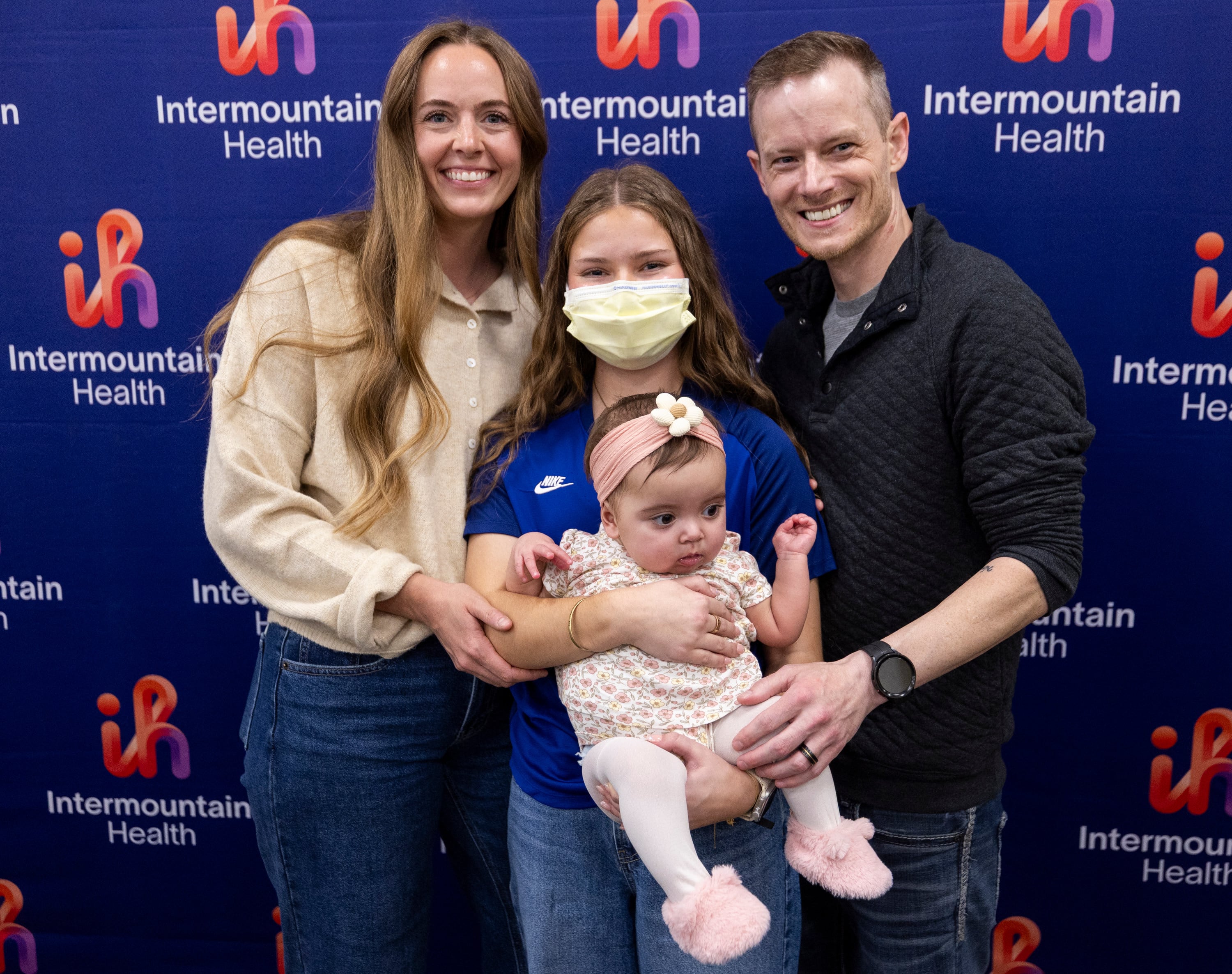 Annie Larrabee, left, Marissa Kauffman, center top, Elieanna Tibbs, center bottom, and her father, Justin, right, pose for a photo during a media event for Utah's first pediatric paired liver exchange at Intermountain Primary Children’s Hospital in Salt Lake City on Friday.