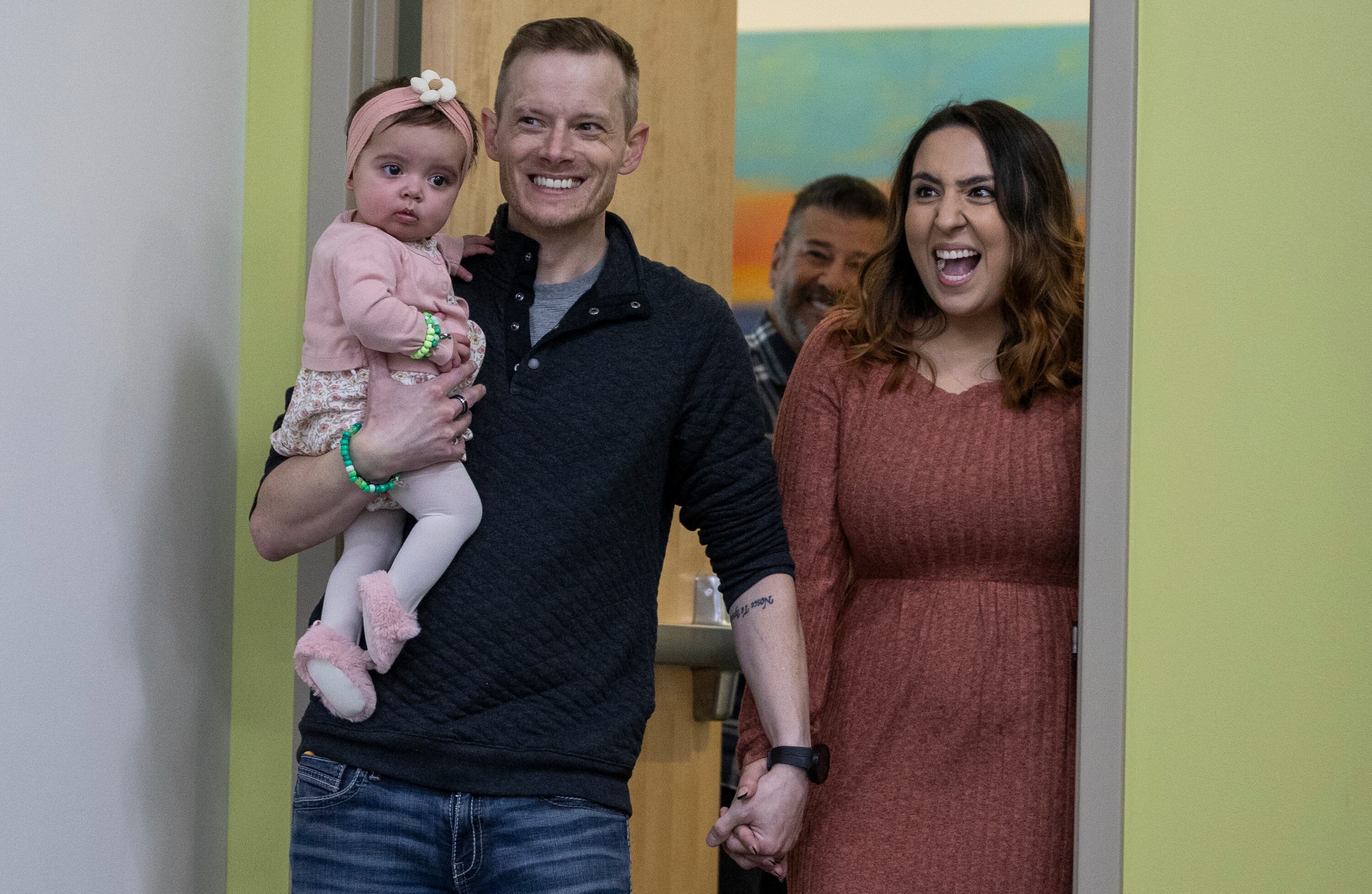 Justin, center, and Jasmyn Tibbs, right, smile as they meet the donor for their daughter Elieanna’s, left, liver transplant and the recipient of Justin’s liver for the first time during a media event for Utah's first pediatric paired liver exchange at Intermountain Primary Children’s Hospital in Salt Lake City on Friday.
