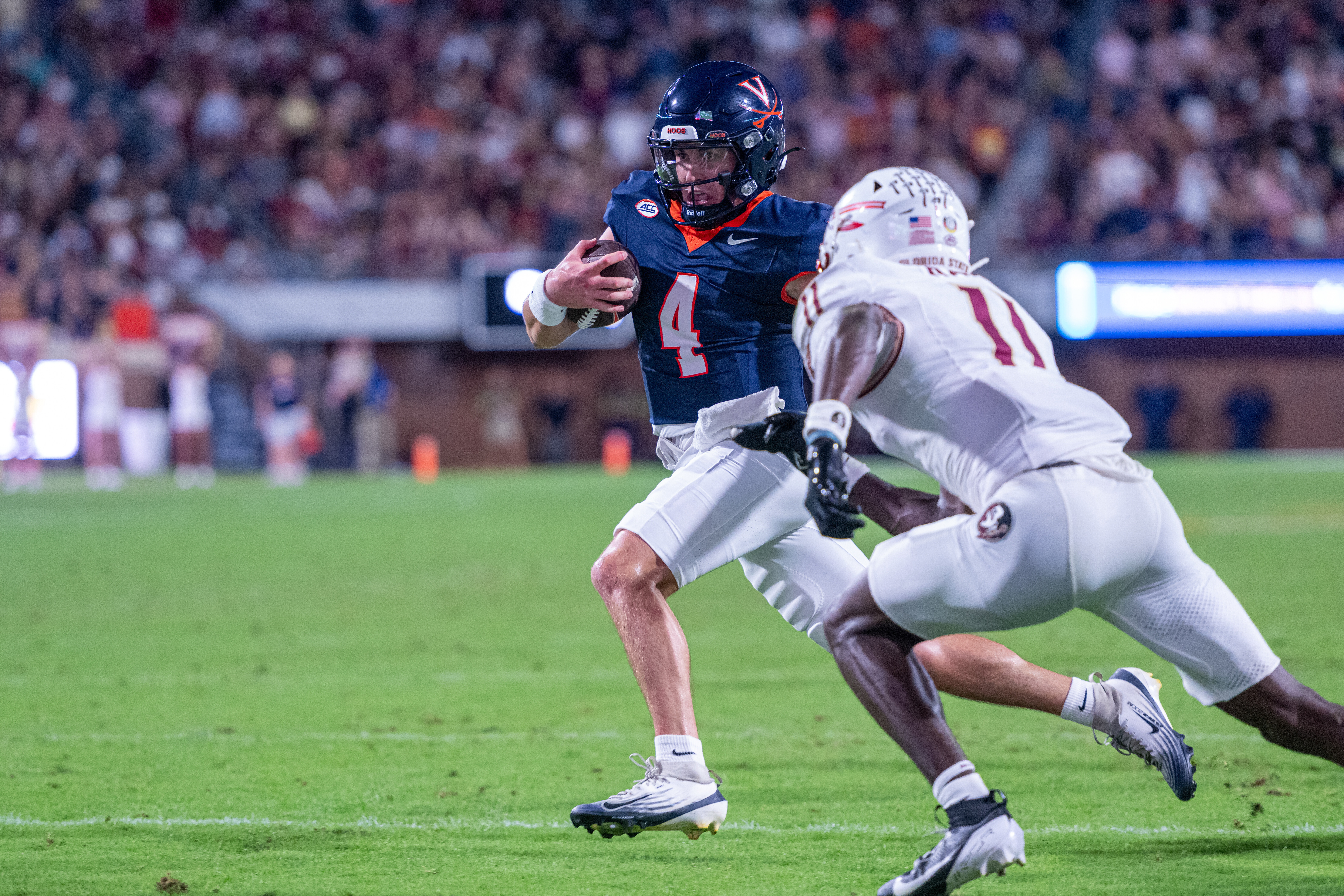 Virginia quarterback Chandler Morris (4) runs the ball in for a touchdown during the first half of an NCAA college football game, Friday, Sept. 26 2025, in Charlottesville, Va.
