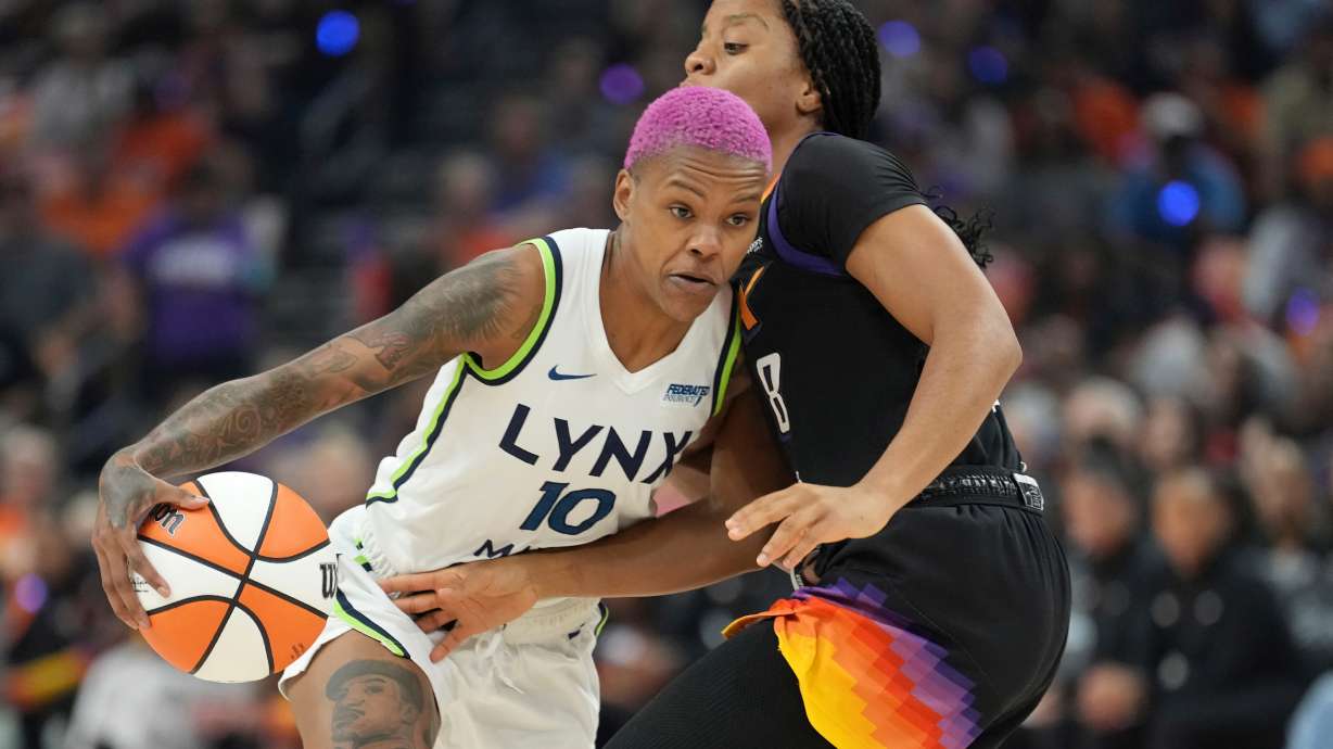 Minnesota Lynx guard Courtney Williams (10) dribbles past Phoenix Mercury guard Monique Akoa Makani (8) during the first half of Game 3 of a WNBA basketball playoff semifinals series game Friday, Sept. 26, 2025, in Phoenix.