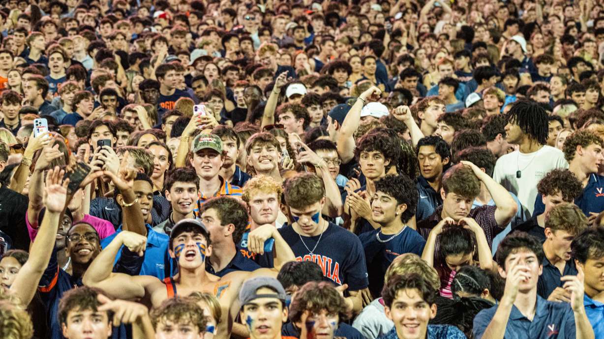 Virginia Fans take the field after overtime win over Florida State of an NCAA college football game, Friday, Sept. 26 2025, in Charlottesville, Va.