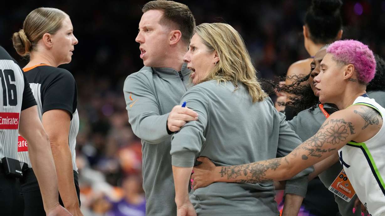 Minnesota Lynx head coach Cheryl Reeve, second from right, yells at officials as she is restrained by Lynx associate head coach Eric Thibault, center, and Lynx guard Natisha Hiedeman, right, after being ejected after earning a second technical foul during the second half of Game 3 of a WNBA basketball playoff semifinals series game against the Phoenix Mercury Friday, Sept. 26, 2025, in Phoenix.