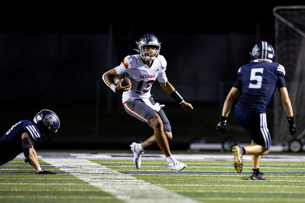Skyridge quarterback Kaneal Sweetwyne (13) runs the ball against Corner Canyon during a high school football game held at Corner Canyon High School in Draper on Friday, Sept. 26, 2025.
