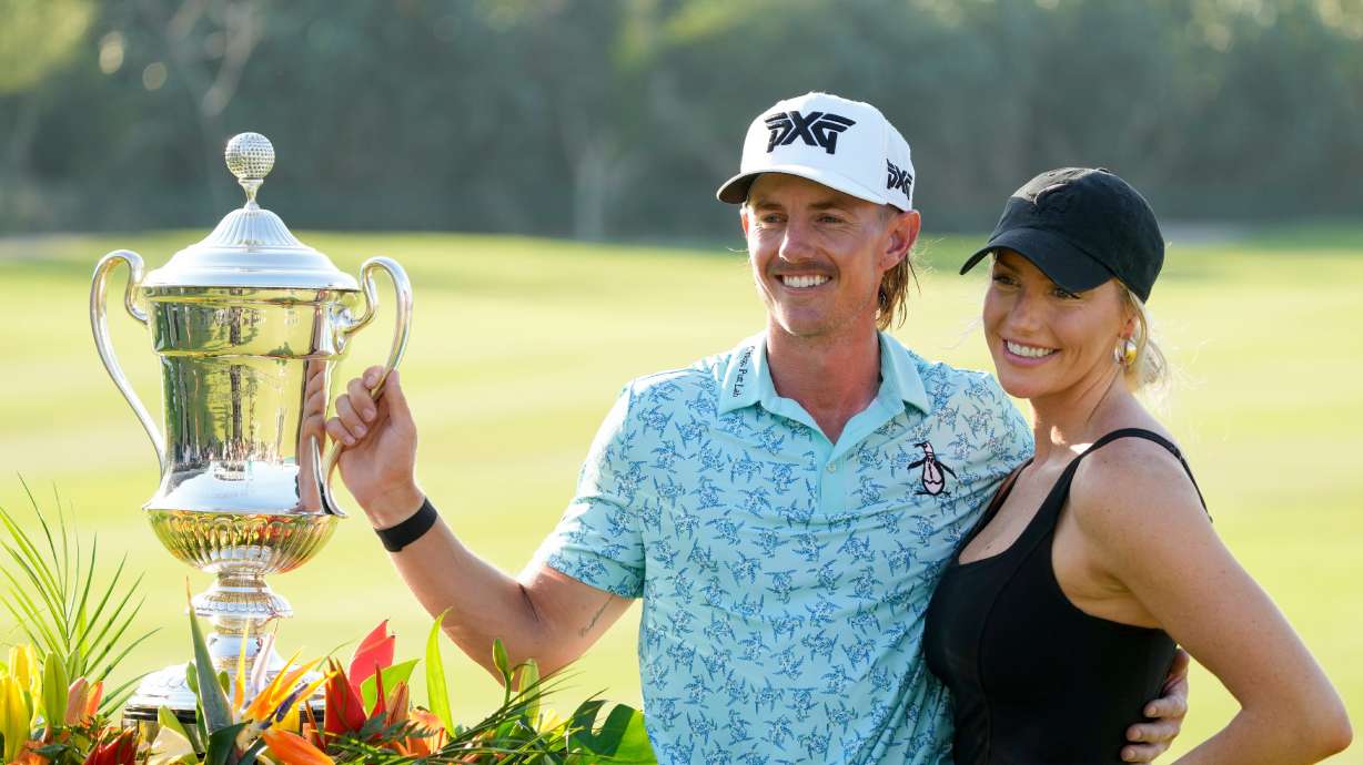 FILE - Jake Knapp, of the United States, and his girlfriend Makena White pose with his trophy during the award ceremony after winning the Mexico Open golf tournament in Puerto Vallarta, Mexico, Sunday, Feb. 25, 2024.