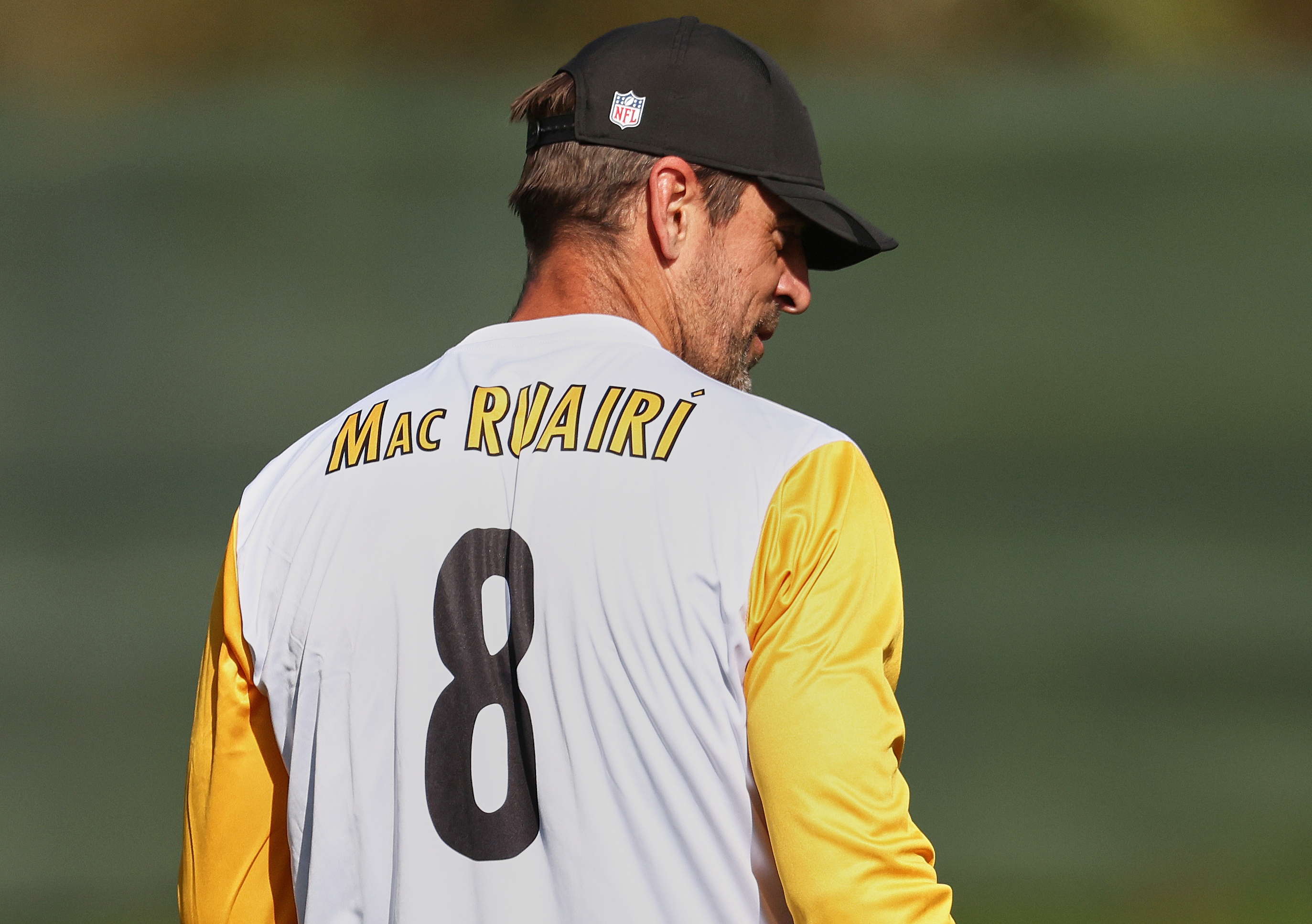 Pittsburgh Steelers quarterback Aaron Rodgers, with his name written in Irish on his shirt, walks onto the field during NFL football practice, Friday, Sept. 26, 2025, ahead of their game against Minnesota Vikings in Dublin.