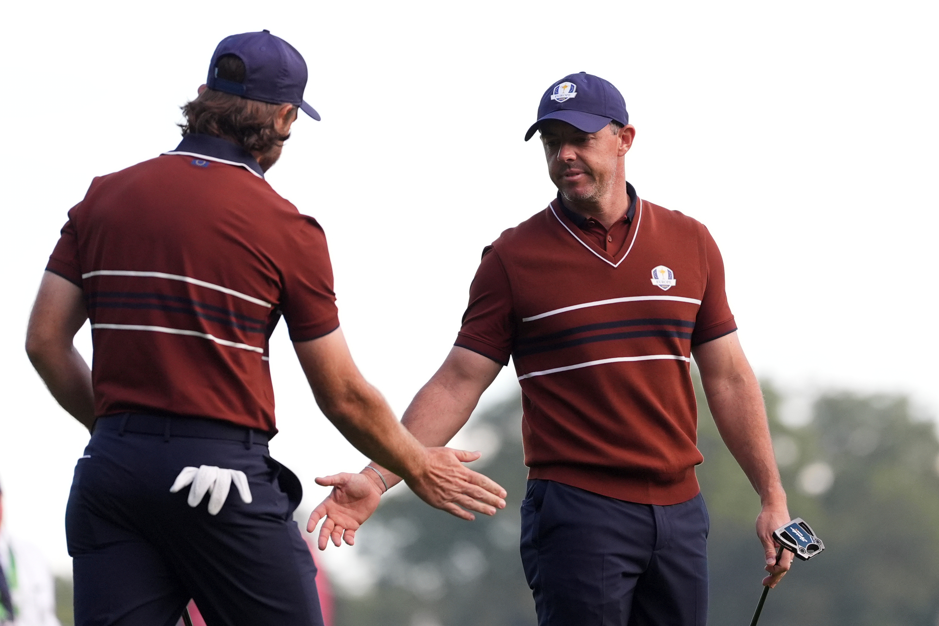 Europe's Tommy Fleetwood celebrates with Rory McIlroy on the third hole at Bethpage Black golf course during the Ryder Cup golf tournament, Saturday, Sept. 27, 2025, in Farmingdale, N.Y.
