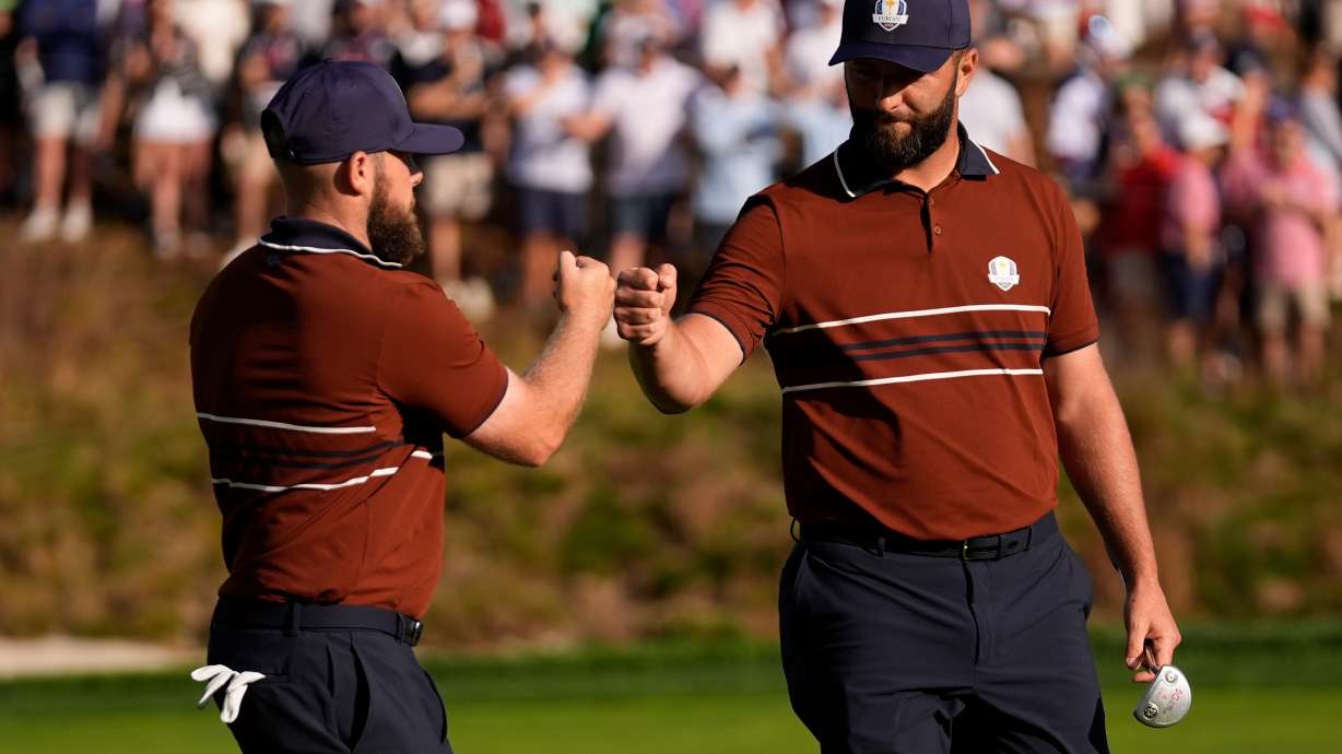Europe's Tyrrell Hatton celebrates with Jon Rahm on the sixth hole at Bethpage Black golf course during the Ryder Cup golf tournament, Saturday, Sept. 27, 2025, in Farmingdale, N.Y.