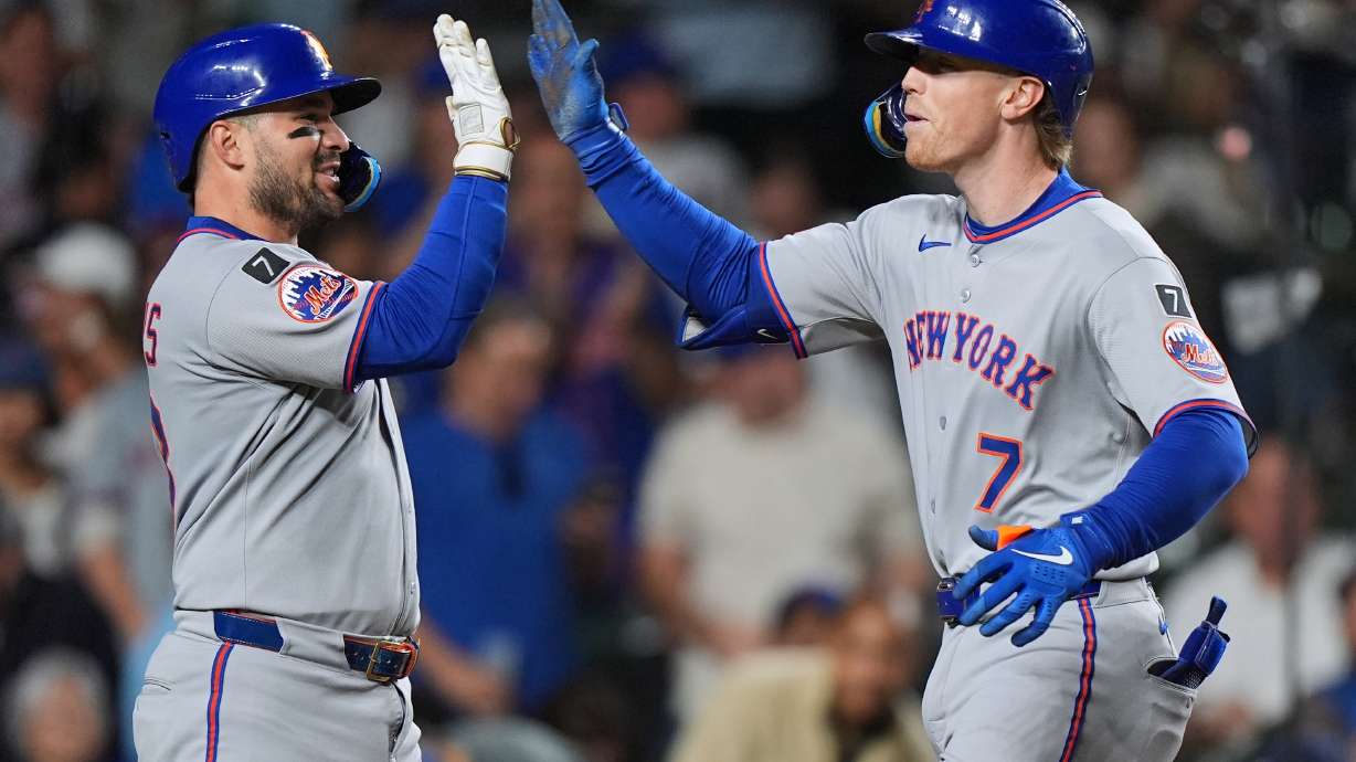 New York Mets' Brett Baty, right, celebrates with Luis Torrens after hitting a three-run home run during the fourth inning of a baseball game against the Chicago Cubs in Chicago, Thursday, Sept. 25, 2025.
