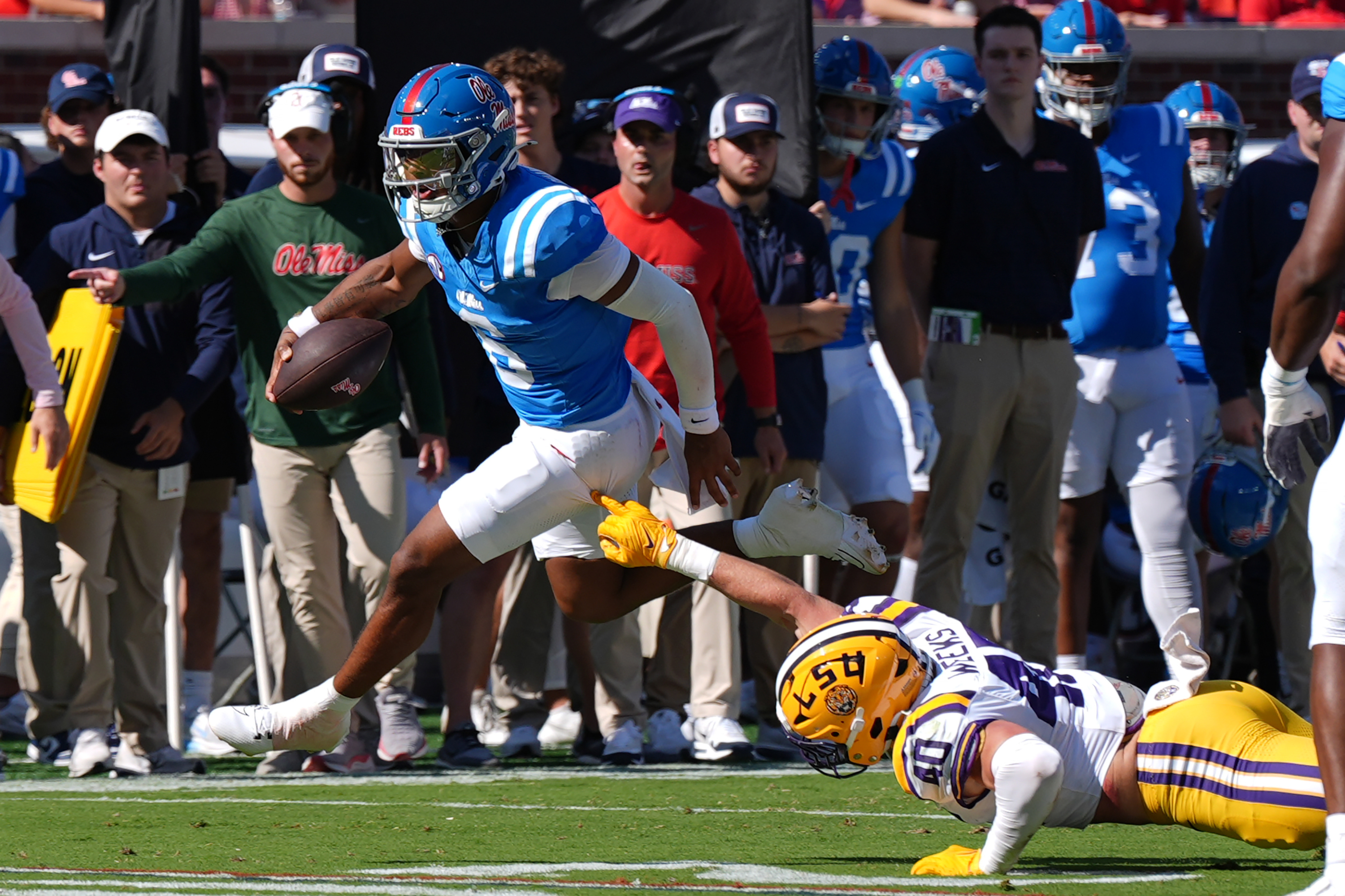 Mississippi quarterback Trinidad Chambliss (6) evades a tackle attempt by LSU linebacker Whit Weeks (40) during the first half of an NCAA college football game in Oxford, Miss., Saturday, Sept. 27, 2025.