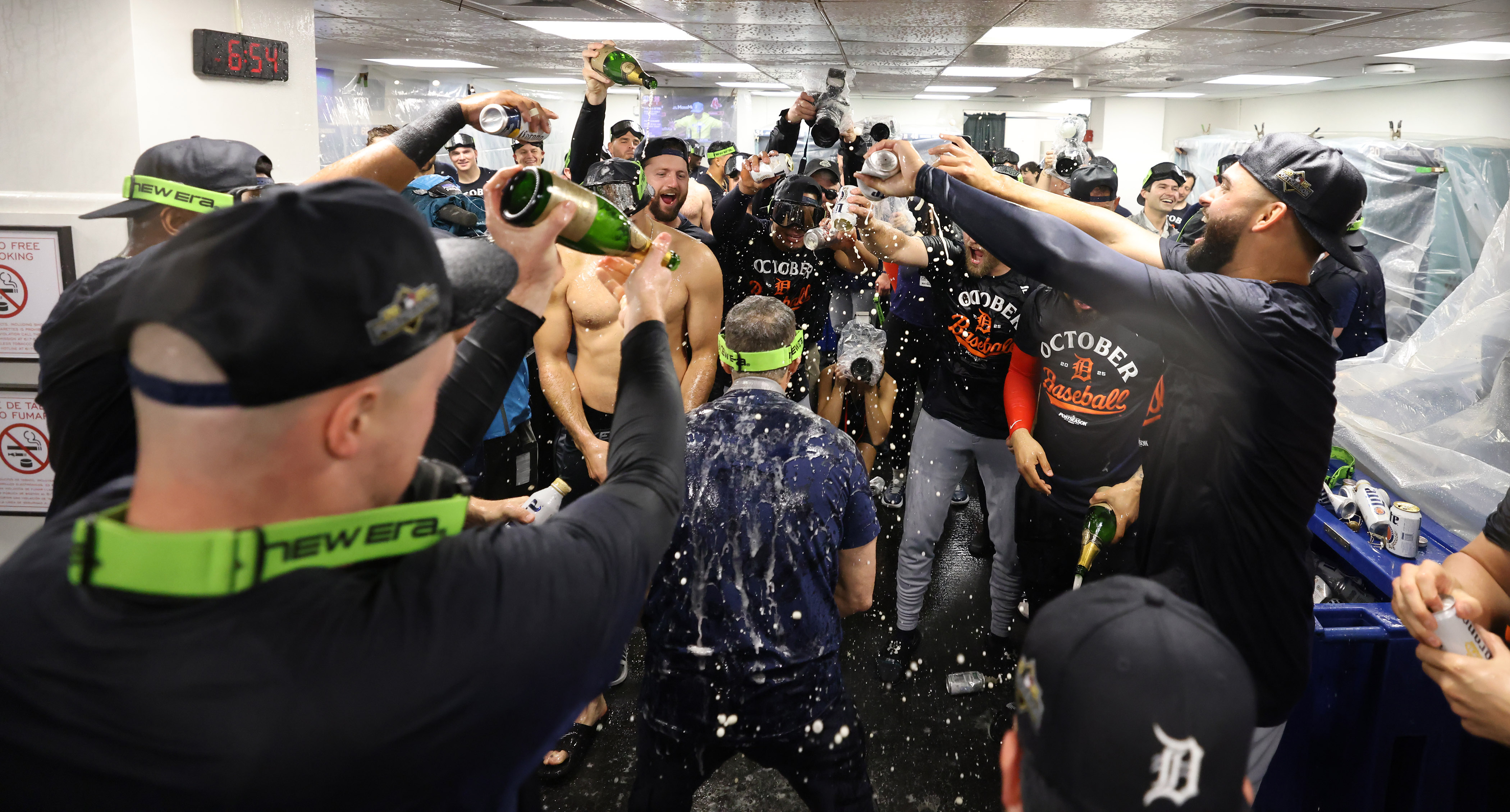 The Detroit Tigers celebrate in the locker room after defeating the Boston Red Sox and clinching a spot in the playoffs, Saturday, Sept. 27, 2025, in Boston. 