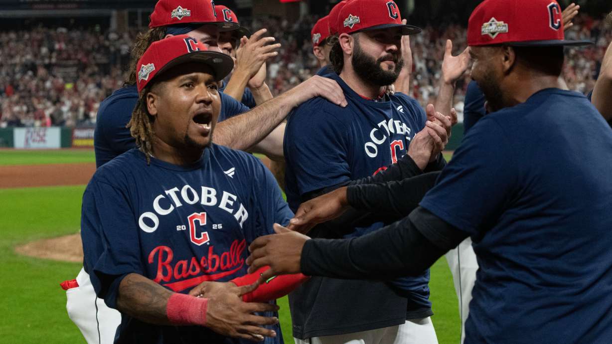 Cleveland Guardians' Jose Ramirez, left, celebrates with his teammates after securing an American League playoff spot at the end of a baseball game against the Texas Rangers, Saturday, Sept. 27, 2025, in Cleveland.