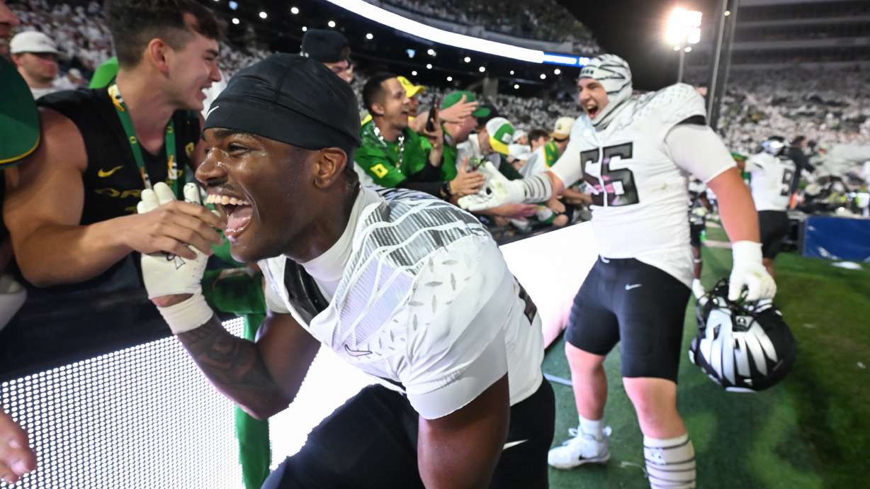 Oregon linebacker Nasir Wyatt (32) and Oregon offensive lineman Trent Ferguson (56) celebrate their second overtime win over Penn State during their NCAA college football game, Saturday, Sept. 27, 2025, in State College, Pa.