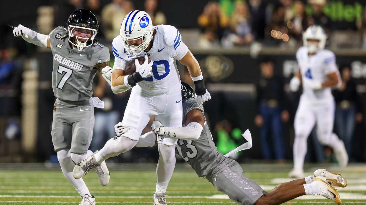 BYU Cougars tight end Carsen Ryan (20) is tackled by Colorado safety Carter Stoutmire (23) during the first half of the game at Folsom Field in Boulder, Colo., on Saturday, Sept. 27, 2025.