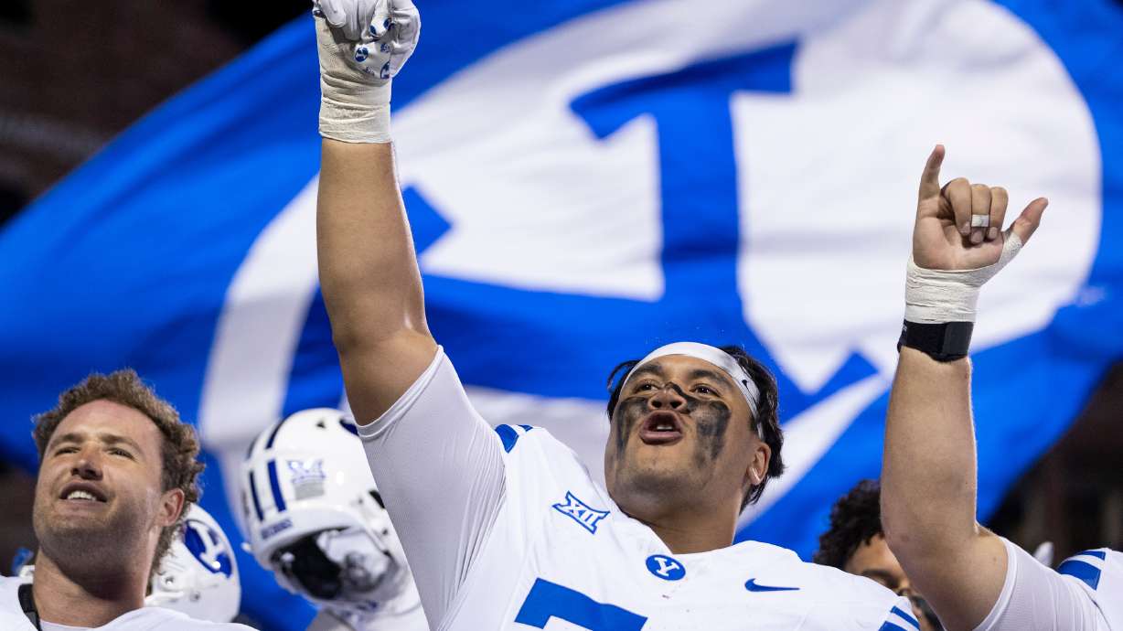 BYU Cougars offensive lineman Trevin Ostler (74) signs the BYU fight song after the game against the Colorado Buffaloes at Folsom Field in Boulder, Colo., on Saturday, Sept. 27, 2025. BYU won 24-21.