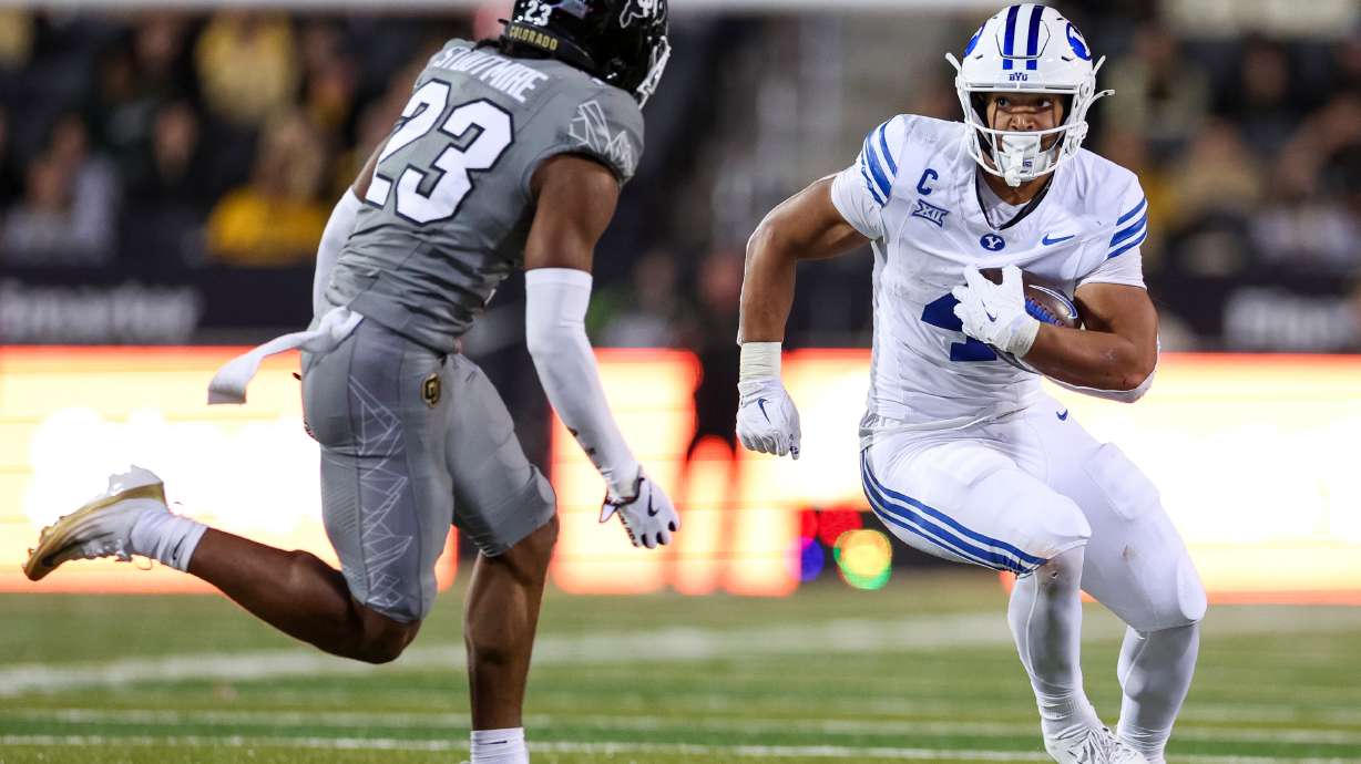 BYU Cougars running back LJ Martin (4) runs against Colorado Buffaloes safety Carter Stoutmire (23) during the second half of the game at Folsom Field in Boulder, Colo., on Saturday, Sept. 27, 2025.