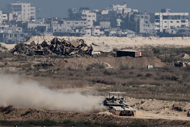 An Israeli tank manoeuvres in Gaza, as seen from the Israeli side of the border, Sunday. President Donald Trump hopes to finalize a Gaza peace plan proposal in a meeting on Monday with Israel's prime minister.