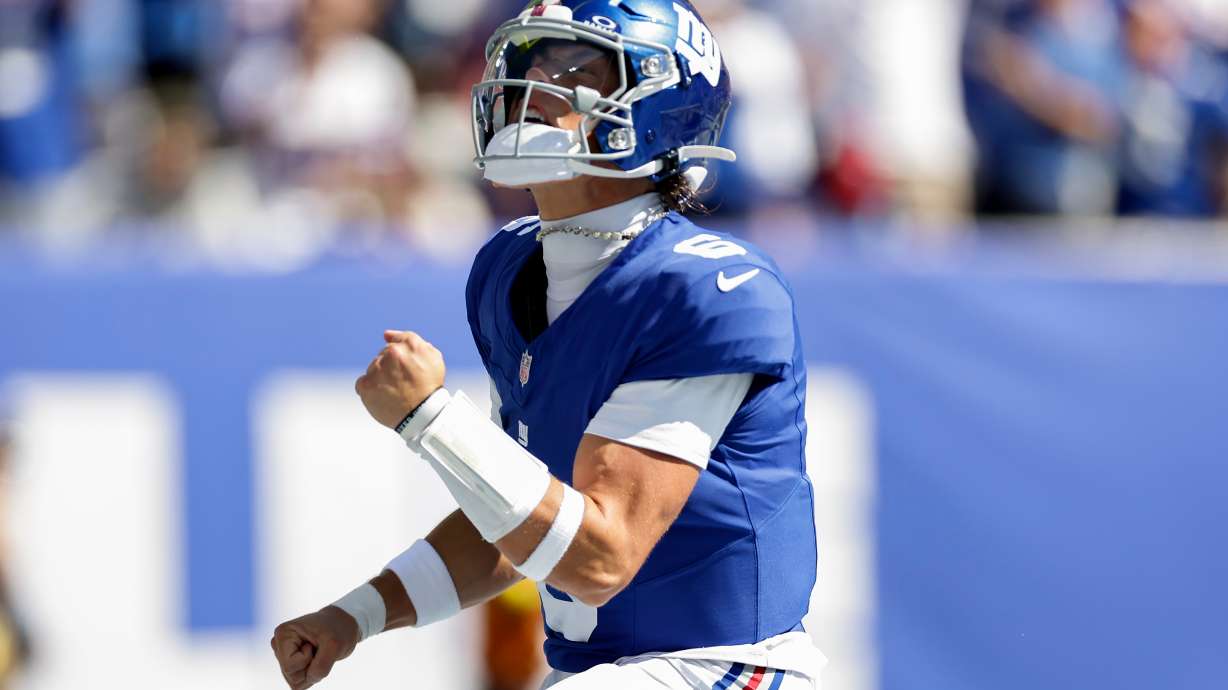 New York Giants quarterback Jaxson Dart (6) reacts after scoring a touchdown against the Los Angeles Chargers during the first quarter of an NFL football game, Sunday, Sept. 28, 2025, in East Rutherford, N.J.