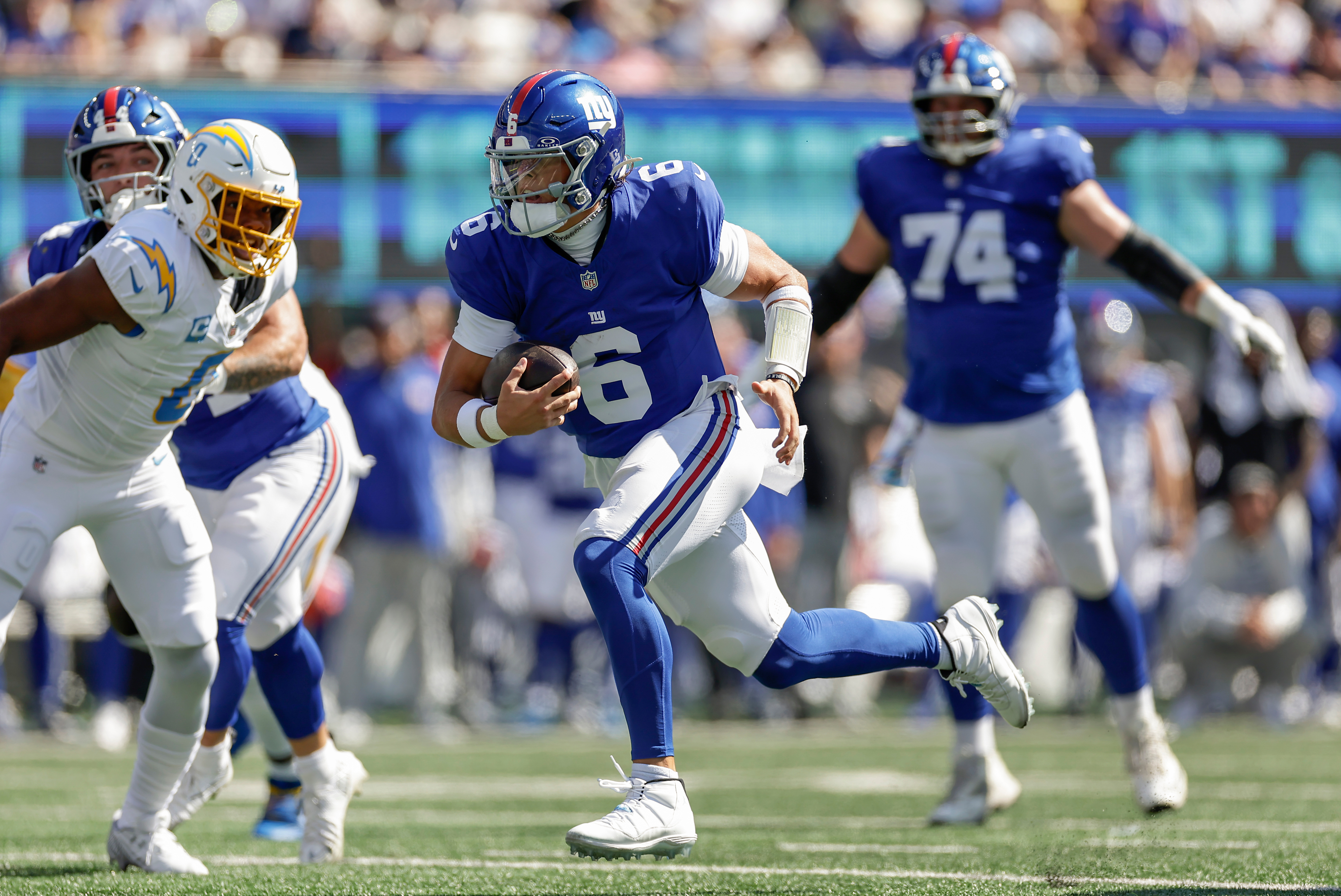 New York Giants quarterback Jaxson Dart (6) carries the ball for a touchdown against the Los Angeles Chargers during the first quarter of an NFL football game, Sunday, Sept. 28, 2025, in East Rutherford, N.J.