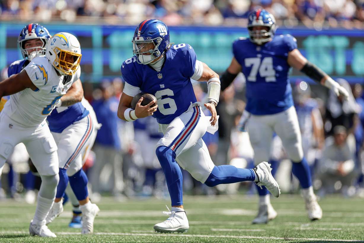 New York Giants quarterback Jaxson Dart (6) carries the ball for a touchdown against the Los Angeles Chargers during the first quarter of an NFL football game, Sunday, Sept. 28, 2025, in East Rutherford, N.J.