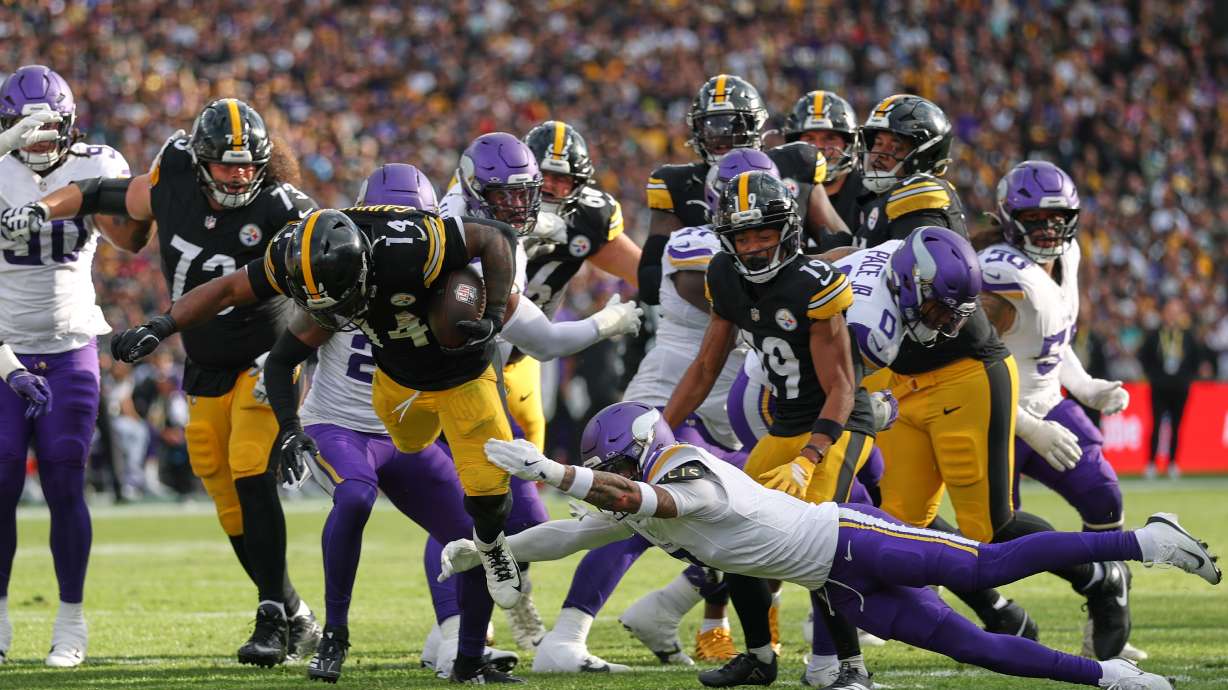 Pittsburgh Steelers running back Kenneth Gainwell (14) is tackled by Minnesota Vikings cornerback Byron Murphy (7) during the NFL football game between Minnesota Vikings and Pittsburgh Steelers at Croke Park stadium in Dublin, Sunday, Sept. 28, 2025.