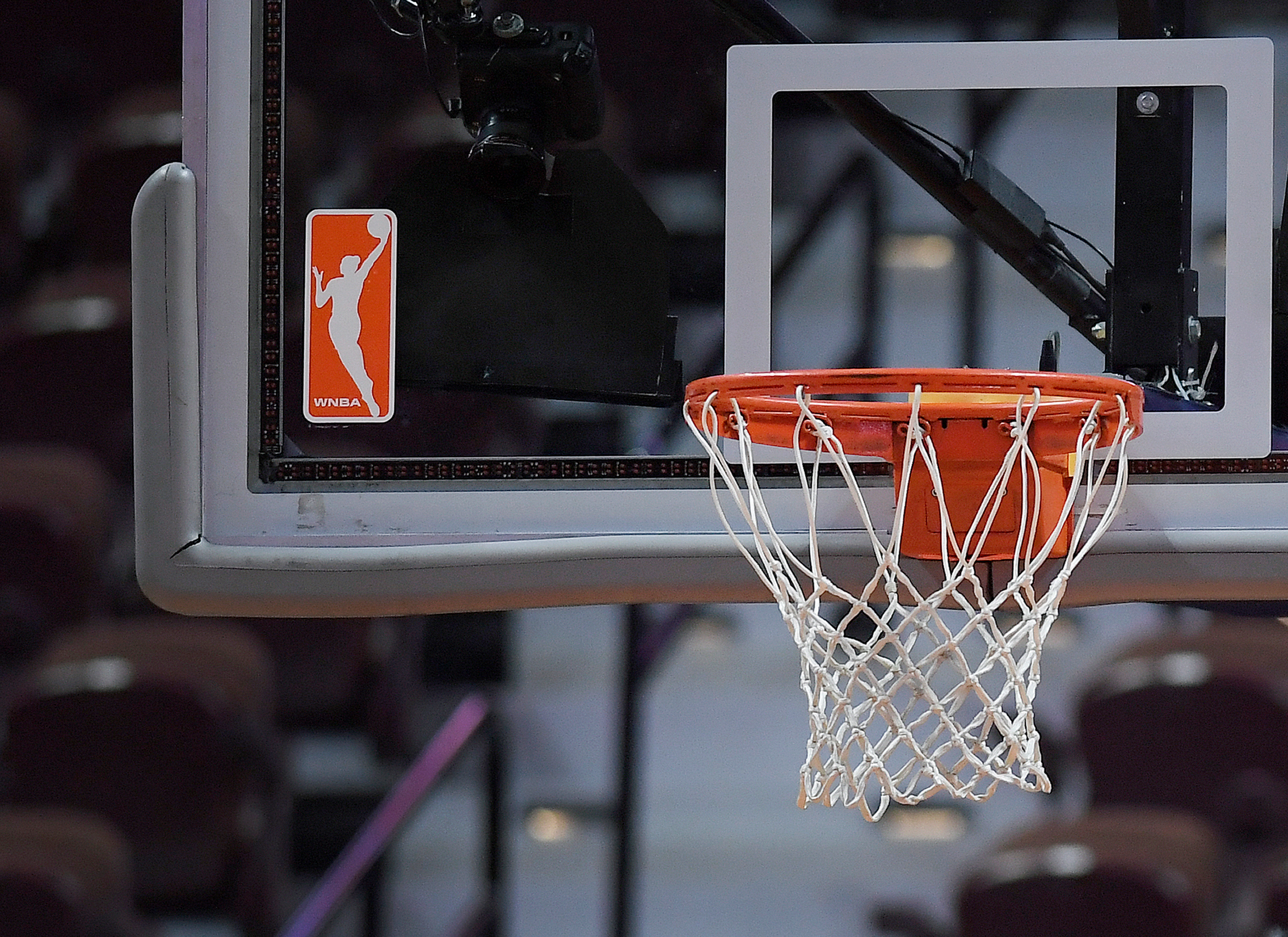 FILE - The WNBA logo and hoop are seen at a WNBA basketball game at Mohegan Sun Arena, Tuesday, May 14, 2019, in Uncasville, Conn.