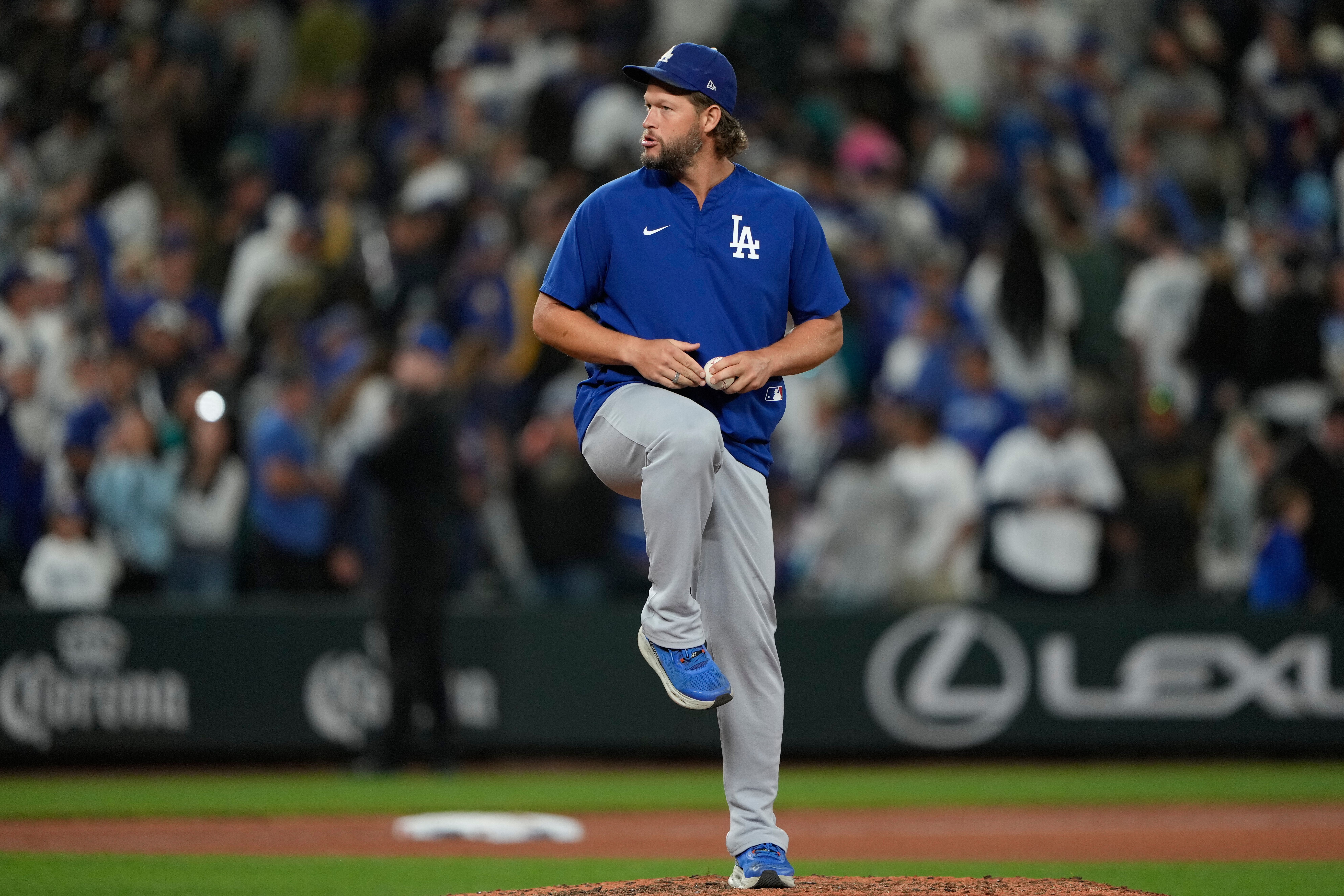 Los Angeles Dodgers starting pitcher Clayton Kershaw pretends to throw on the mound after the team's win in a baseball game against the Seattle Mariners, Friday, Sept. 26, 2025, in Seattle. 