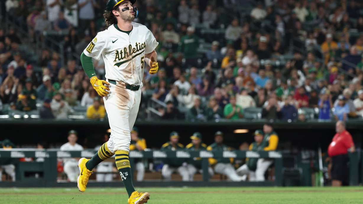 Athletics' Jacob Wilson takes first base after getting hit by a pitch from Kansas City Royals pitcher Carlos Estévez, not shown, during the ninth inning of a baseball game Saturday, Sept. 27, 2025, in West Sacramento, Calif.