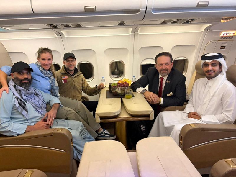 Amir Amiri, who had been detained in Afghanistan since December 2024, poses for a picture alongside Adam Boehler, the U.S. special envoy for hostage response, Sebastian Gorka, the deputy assistant to the U.S. president and senior director for counterterrorism, and a Qatari diplomat, on a plane from Kabul Afghanistan, Sunday. 