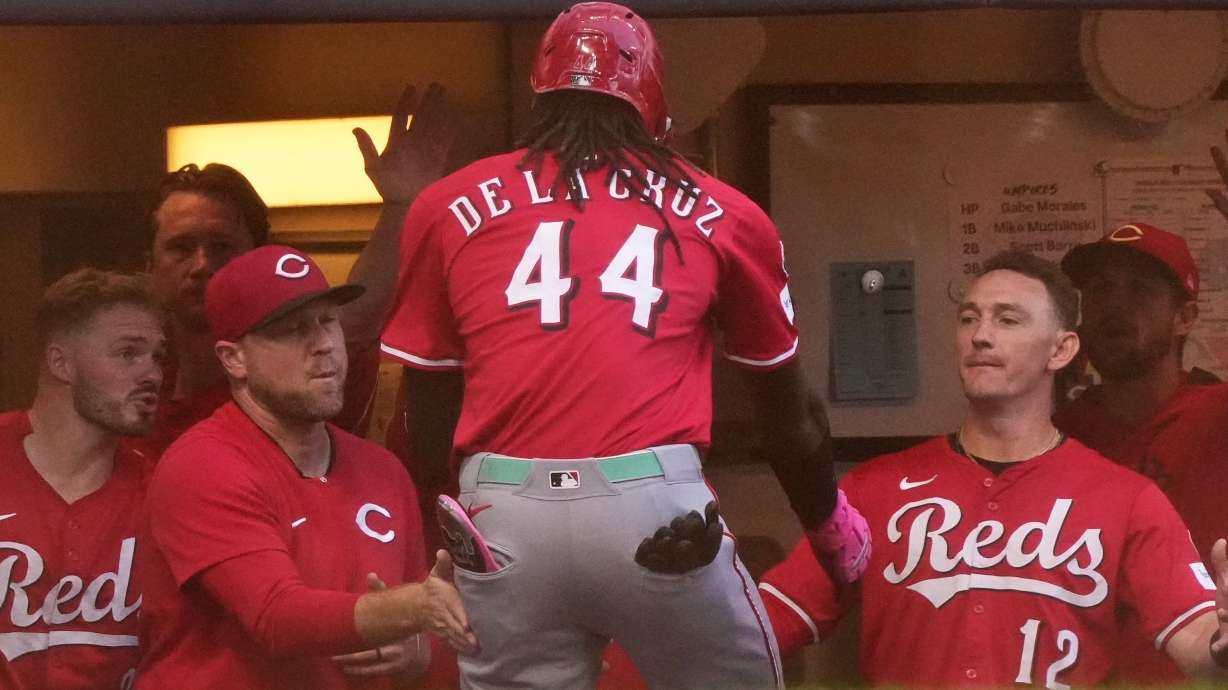 Cincinnati Reds' Elly De La Cruz is congratulated after hitting a home run during the second inning of a baseball game against the Milwaukee Brewers Sunday, Sept. 28, 2025, in Milwaukee.