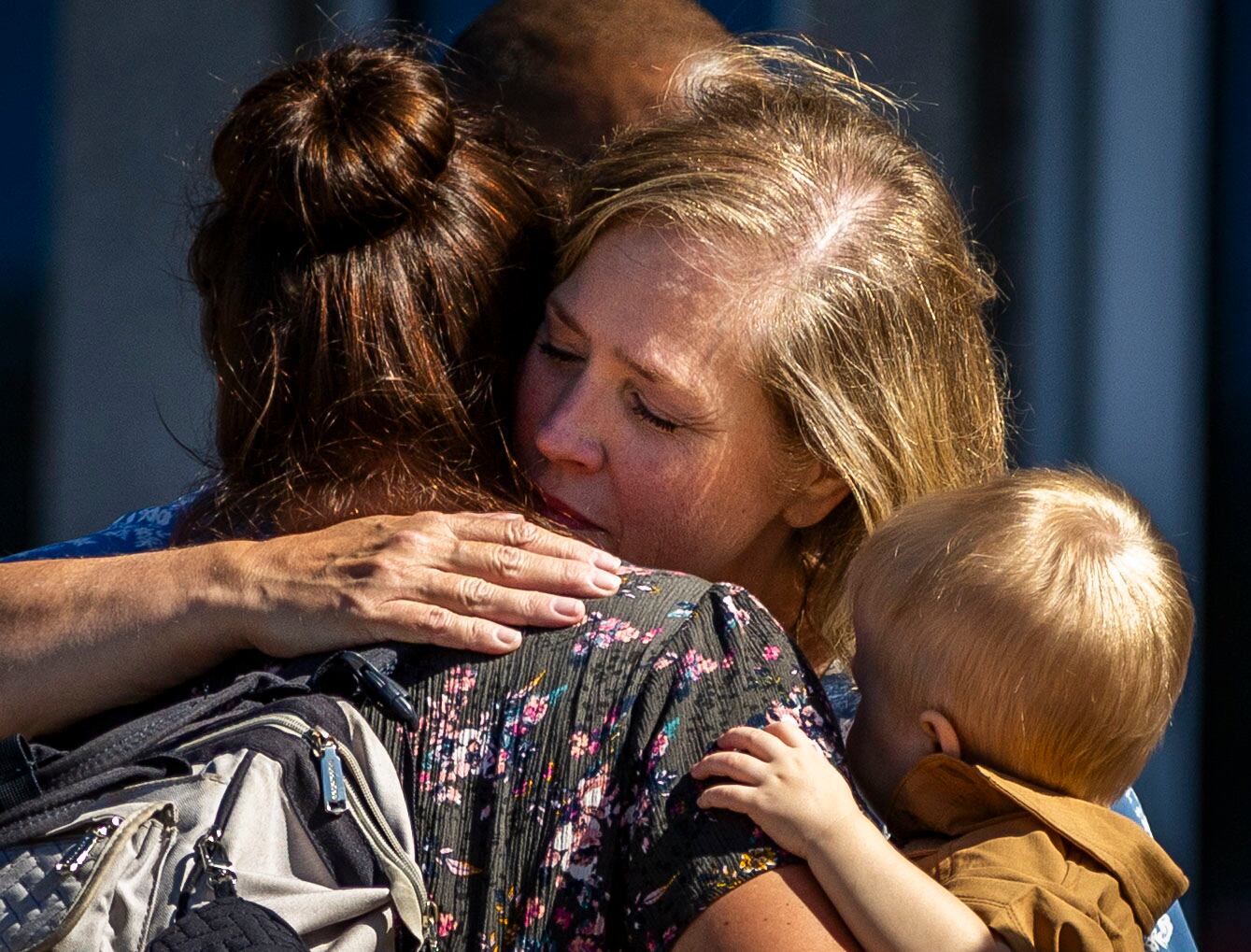 Stephanie Rossello, a member of the Grand Blanc Ward, hugs a friend after their exit from a reunification center following a fire and shooting at a meetinghouse of The Church of Jesus Christ of Latter-day Saints in Grand Blanc Township, Mich., on Sunday.