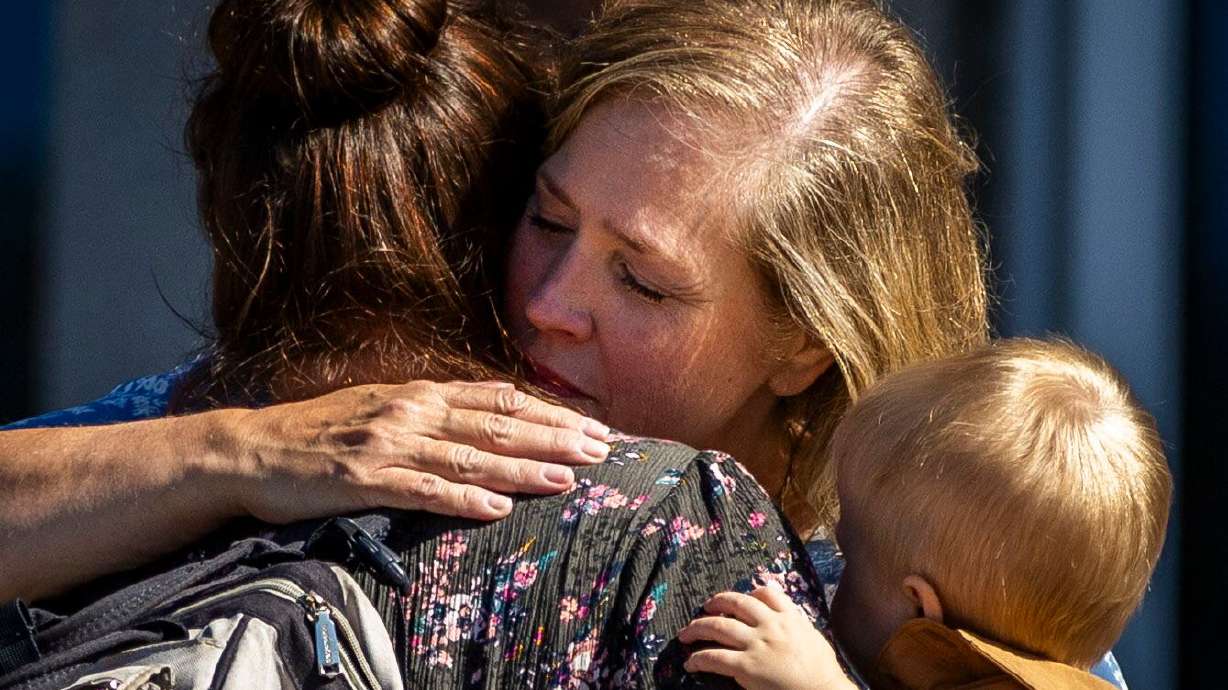 Stephanie Rossello, a member of the Grand Blanc Ward, hugs a friend after their exit from a reunification center following a fire and shooting at a meetinghouse of The Church of Jesus Christ of Latter-days Saints in Grand Blanc Township, Mich., on Sunday.